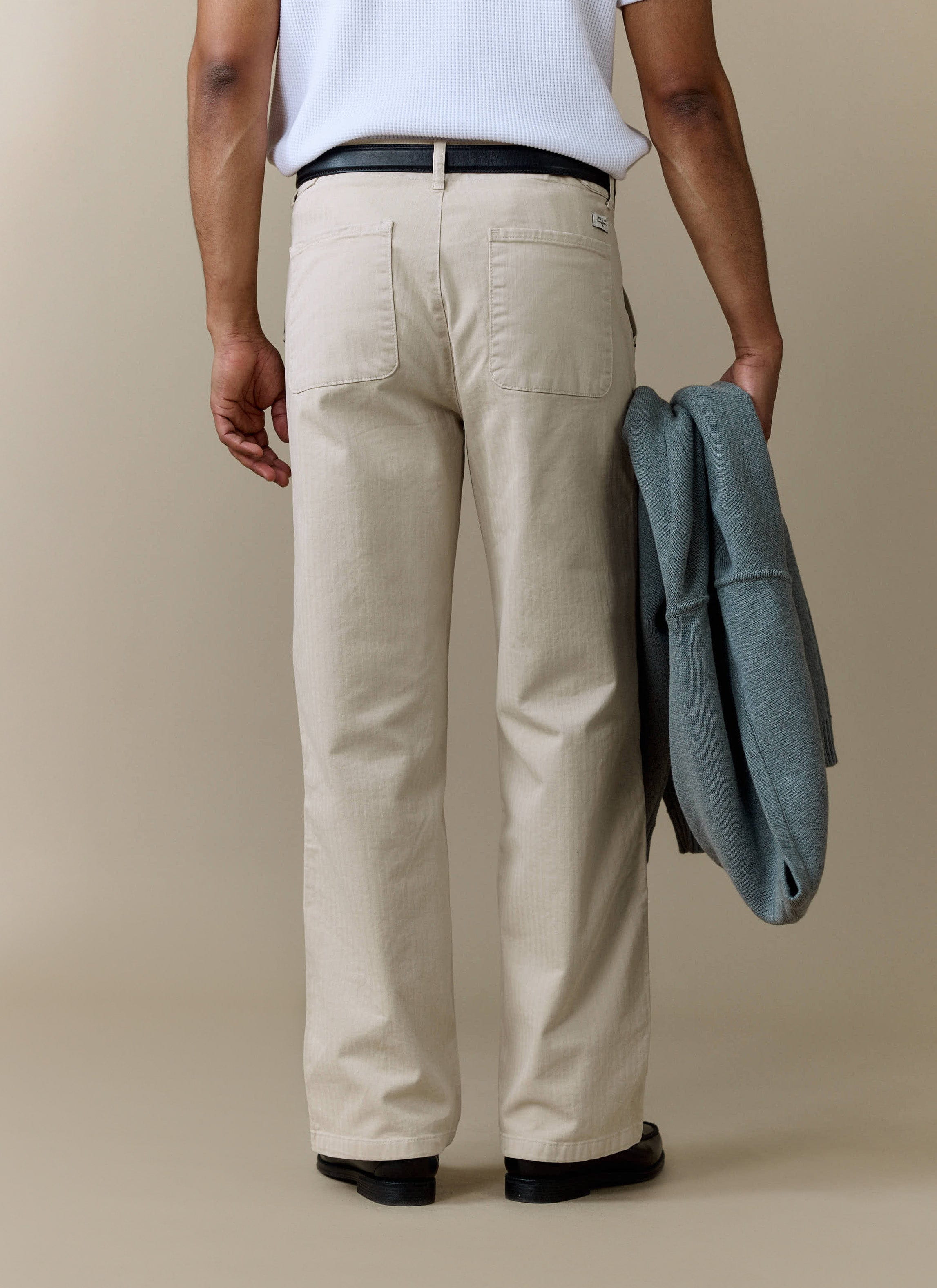Rear view of the Percival Lungo Herringbone Straight Trousers in ecru, showing the straight leg fit and back pockets.