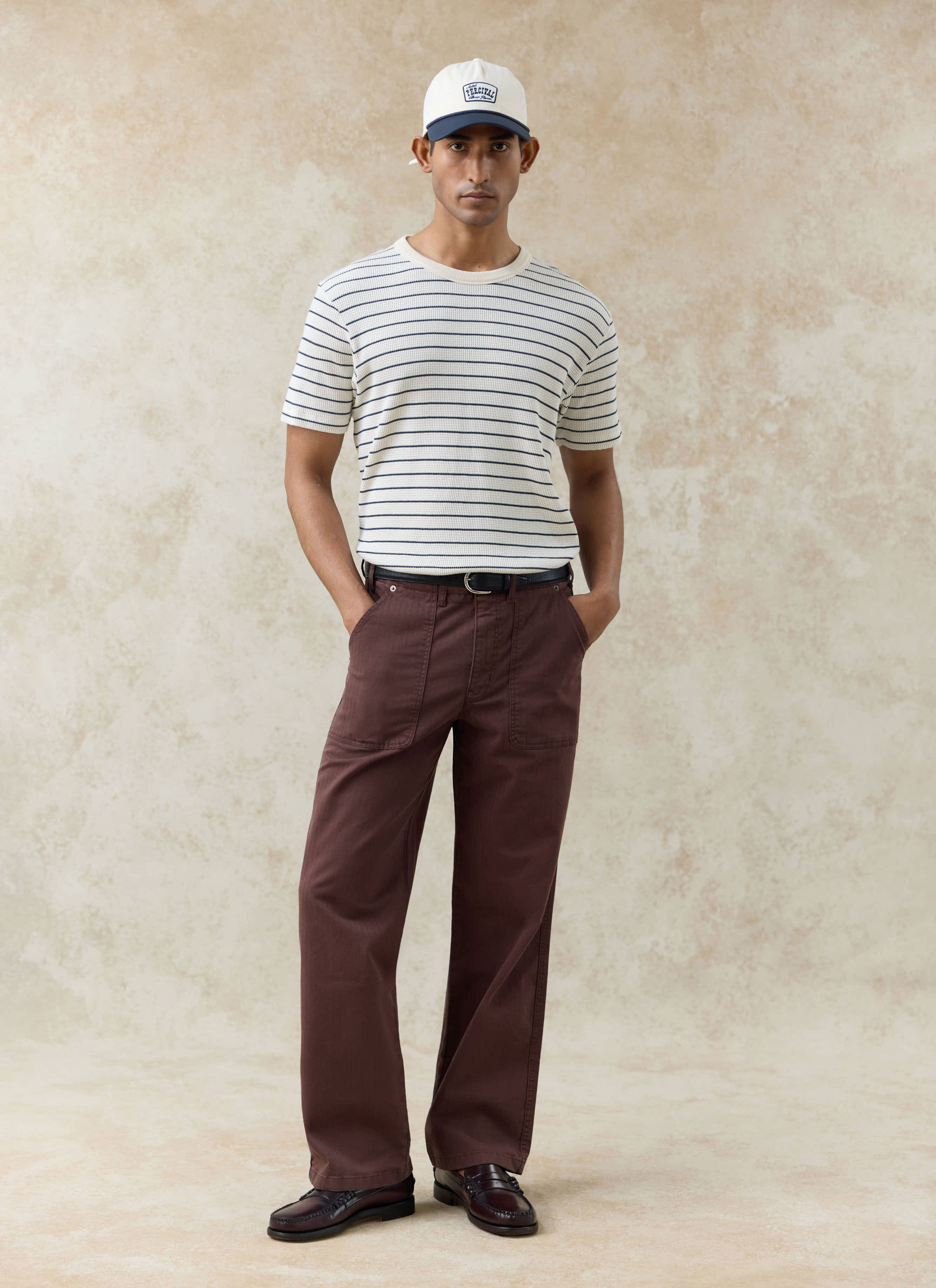Model wears the Percival Ernie waffle T-shirt in cream stripe, a textured organic cotton top with navy Breton stripes.