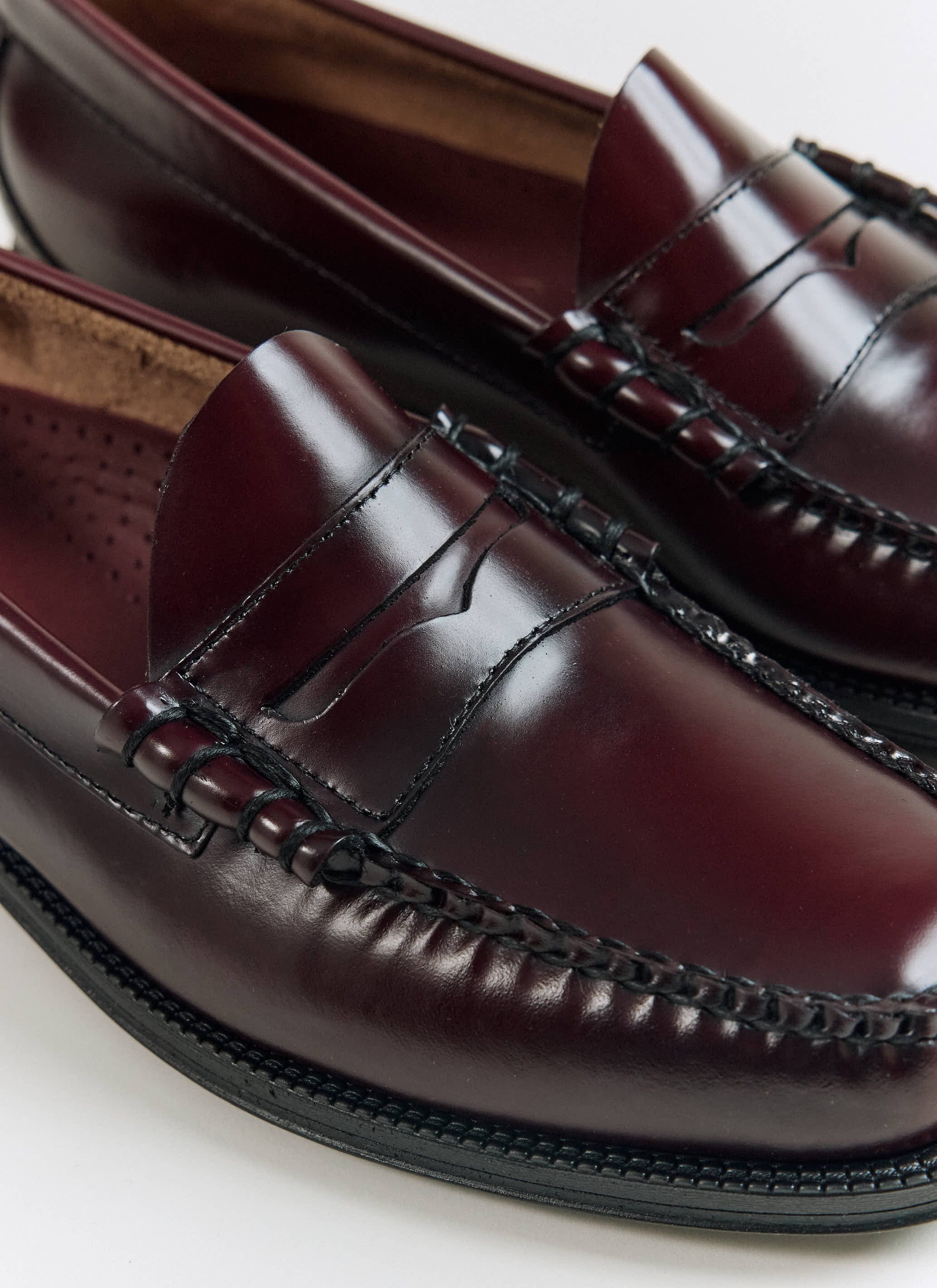 A close-up of the wine leather G.H.Bass Weejun II Larson Moc Penny loafers from Percival, showing the hand-stitched seams.