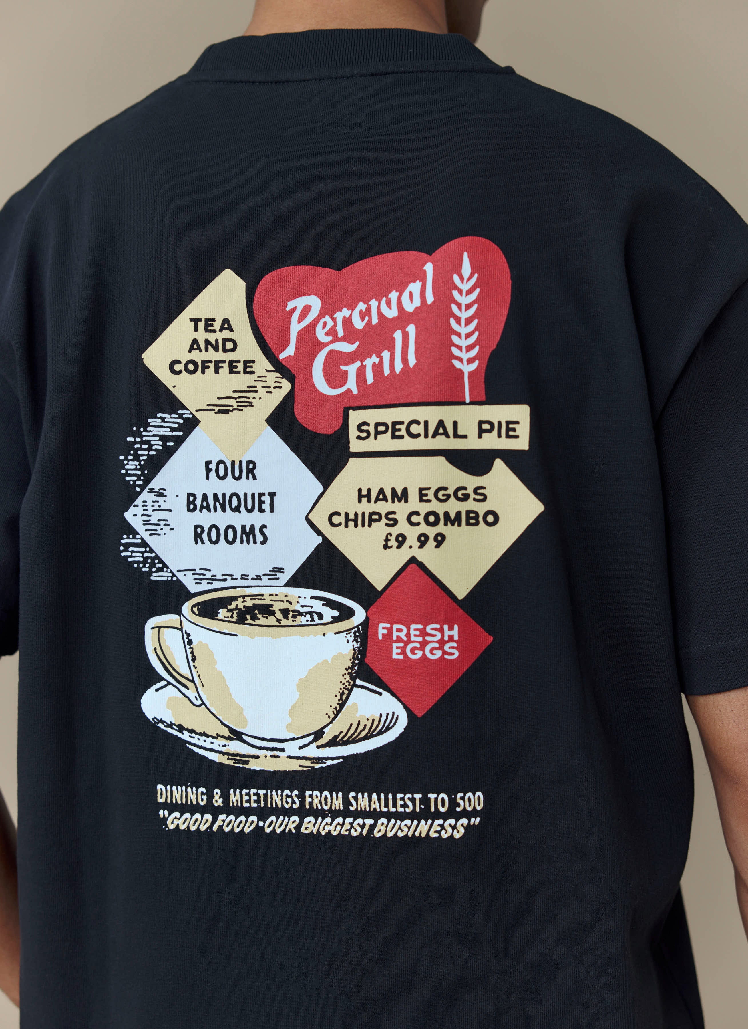 Close-up of the back of the black Percival Grill T-shirt, showing the retro diner-style graphic.
