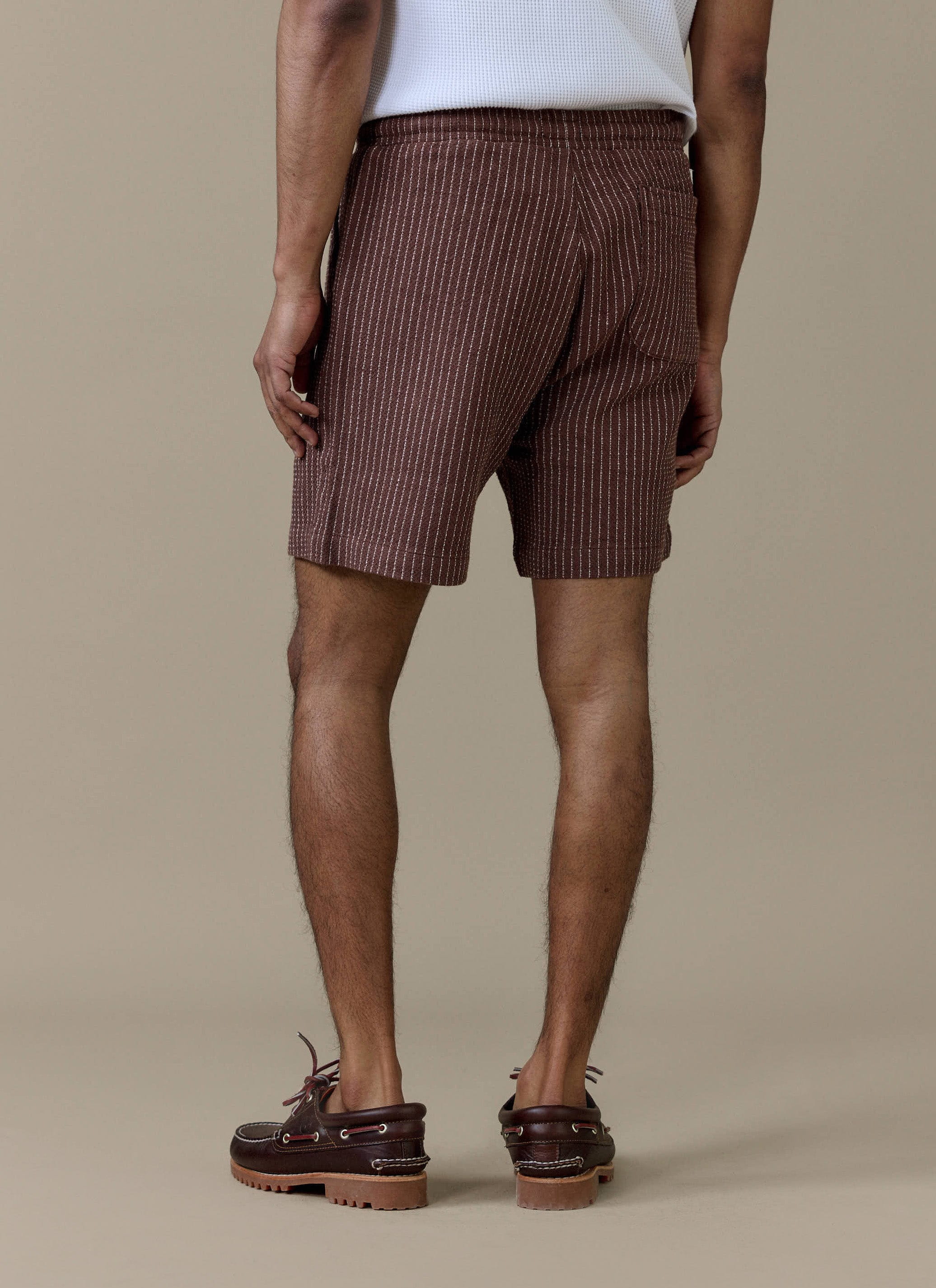 Rear view of the Percival Sorrento Linen Shorts in brown pinstripe, showing the back pocket and elasticated waistband.