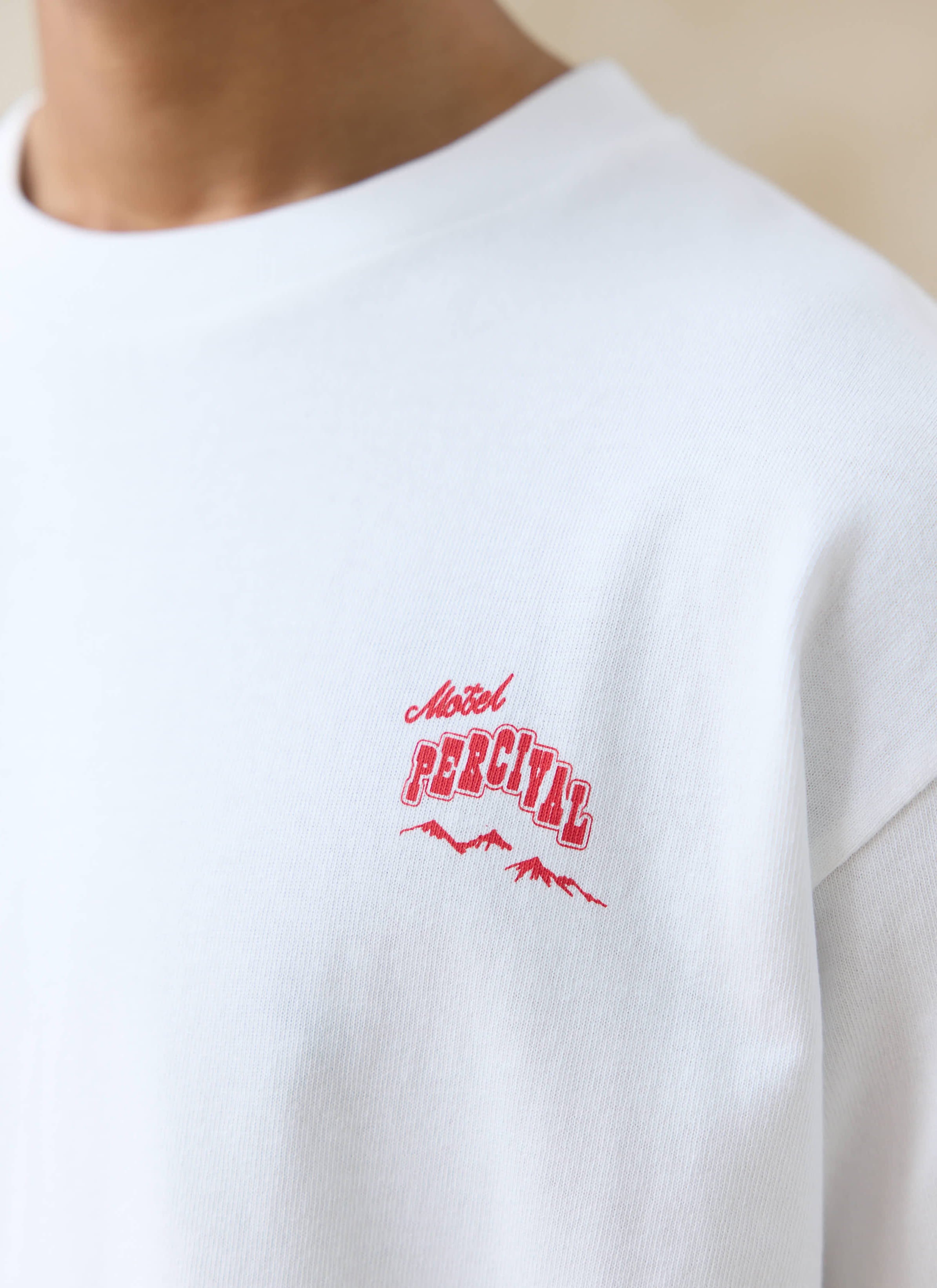 Close-up of the red Motel Percival chest print on a white organic cotton Gordon Oversized T Shirt from Percival.