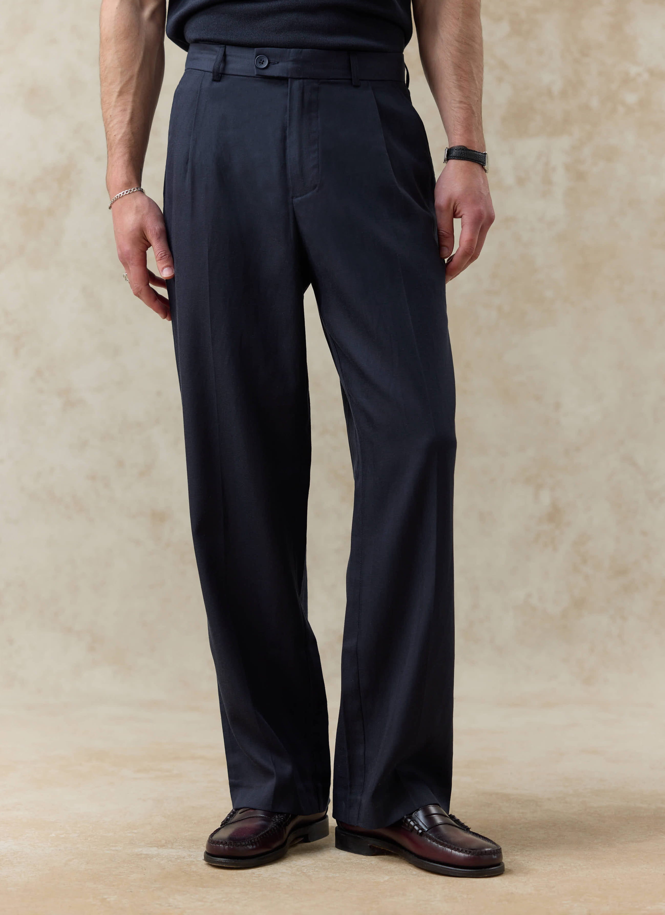 Percival Pleated Leg Trousers in navy blue lyocell, featuring a relaxed fit and soft tailored drape on a model.