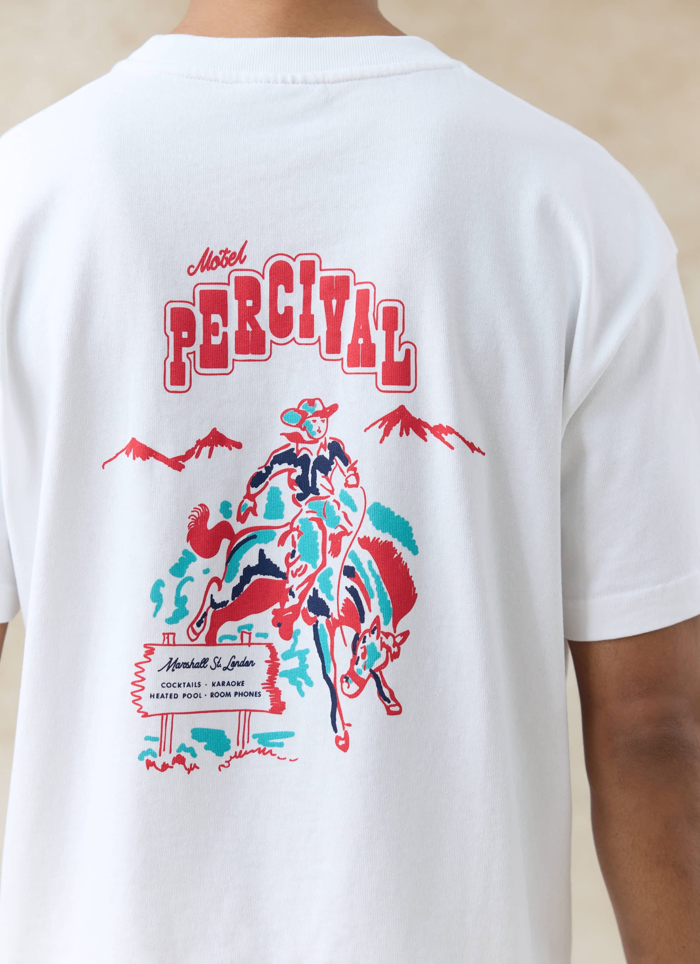 Motel Percival cowboy postcard graphic in red and blue on the back of a white organic cotton oversized T Shirt.
