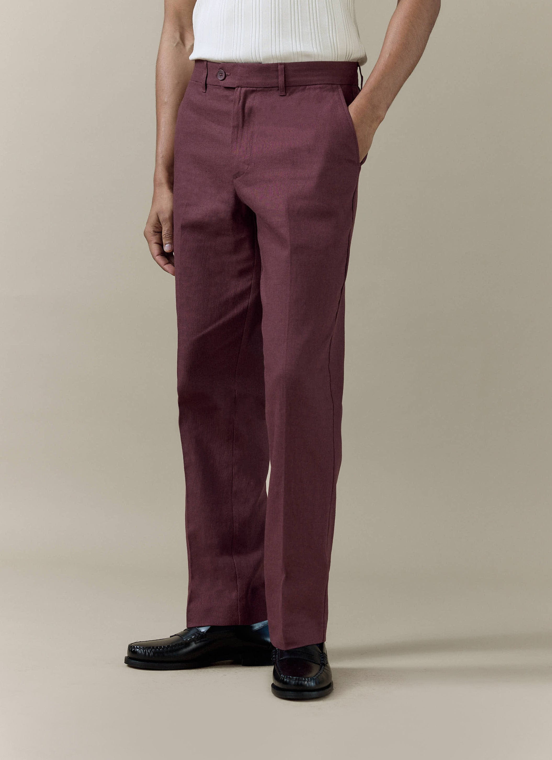 Merlot tailored linen trousers by Percival, featuring a sharp pressed crease and a straight-leg fit.