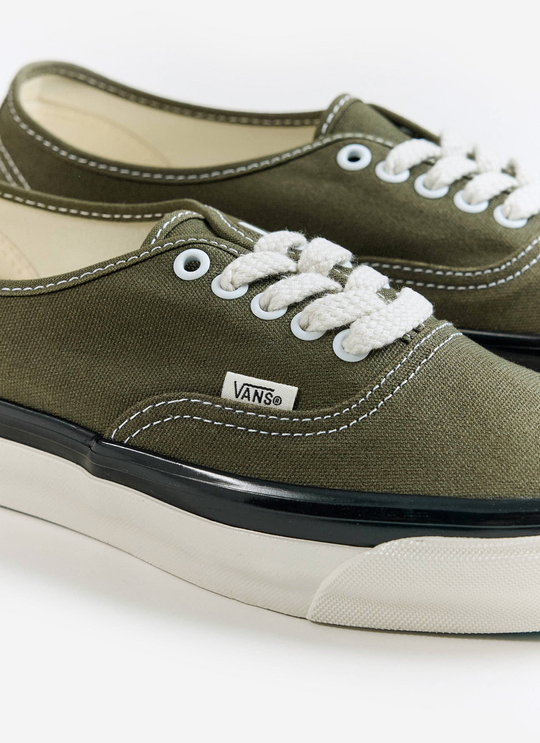 A close-up of the olive green Vans Premium Authentic 44 Shoes at Percival, showing the canvas and white laces.