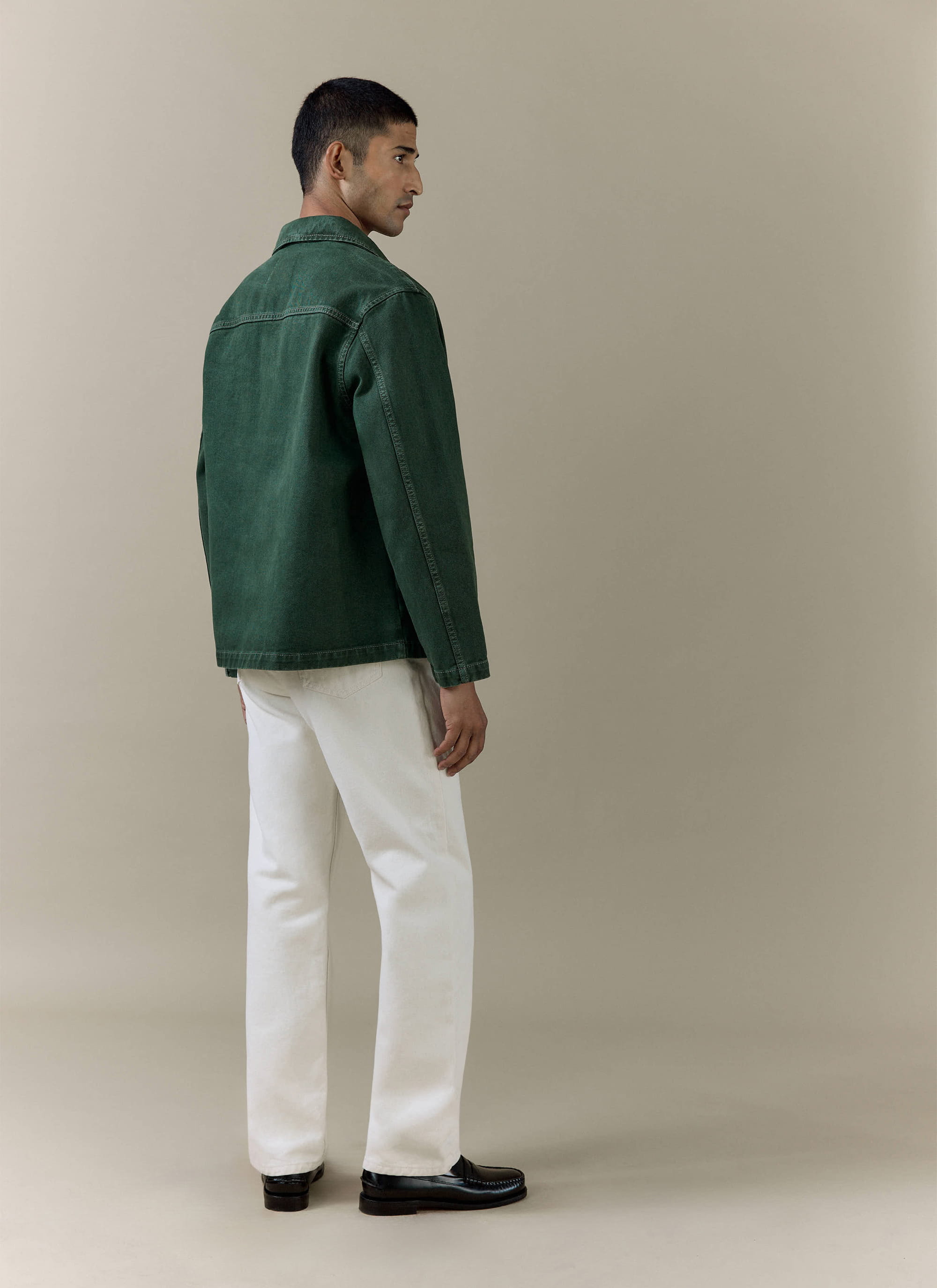 Back view of a model wearing the Percival forest green Vintage Wash Oliver Chore Jacket in cotton canvas.