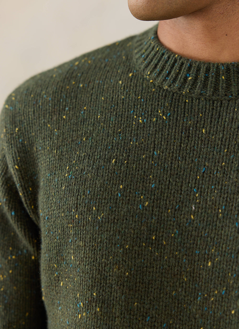 Close-up of the forest green Percival Rhodes crew neck jumper, showcasing the colourful flecks and ribbed cotton blend knit.