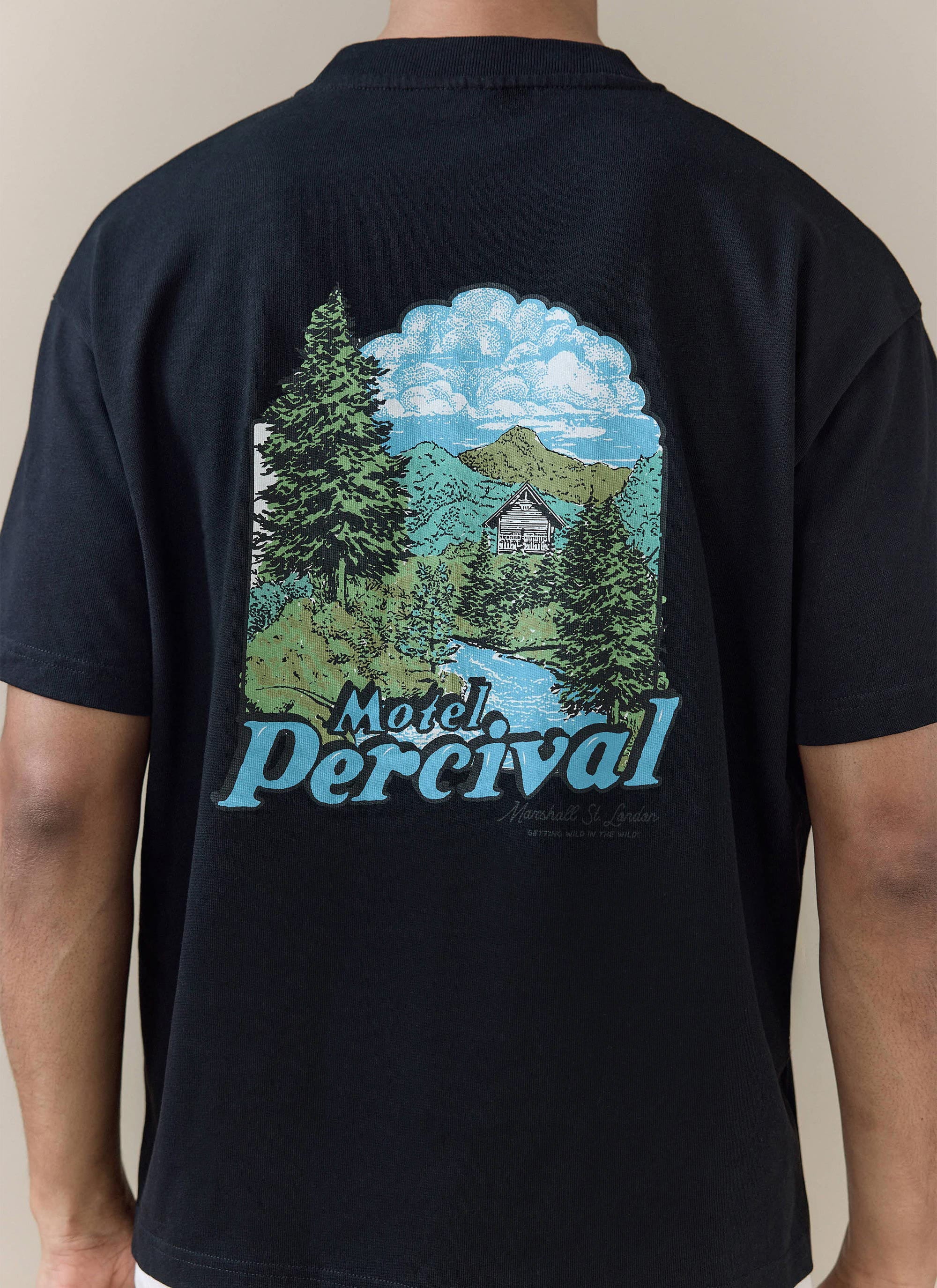 Percival Arnold Oversized T Shirt in black organic cotton, featuring a scenic 'Motel Percival' mountain back graphic.