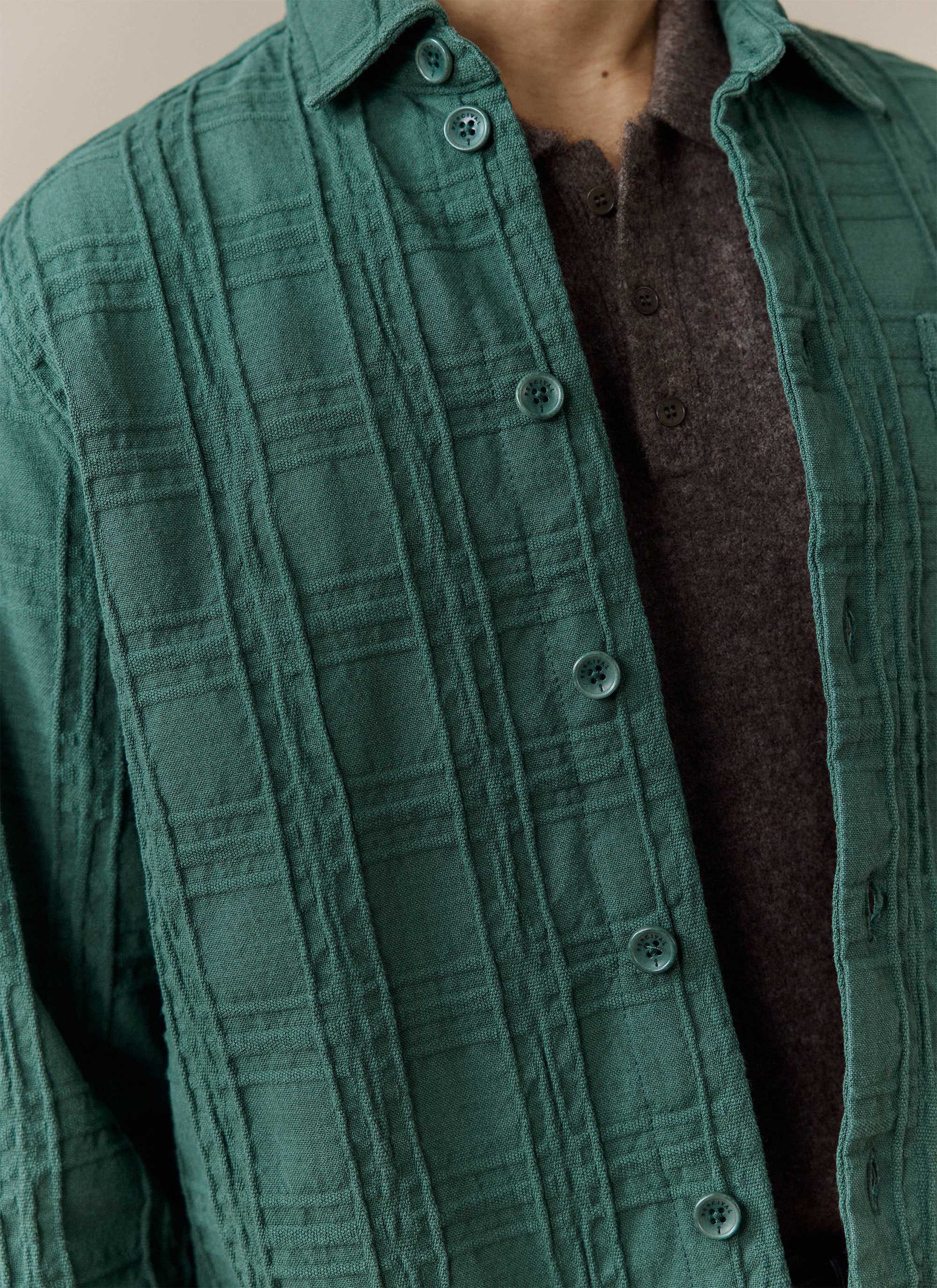 Detail shot of the forest green Canyon Heavyweight Overshirt from Percival, highlighting the textured woven cotton fabric.