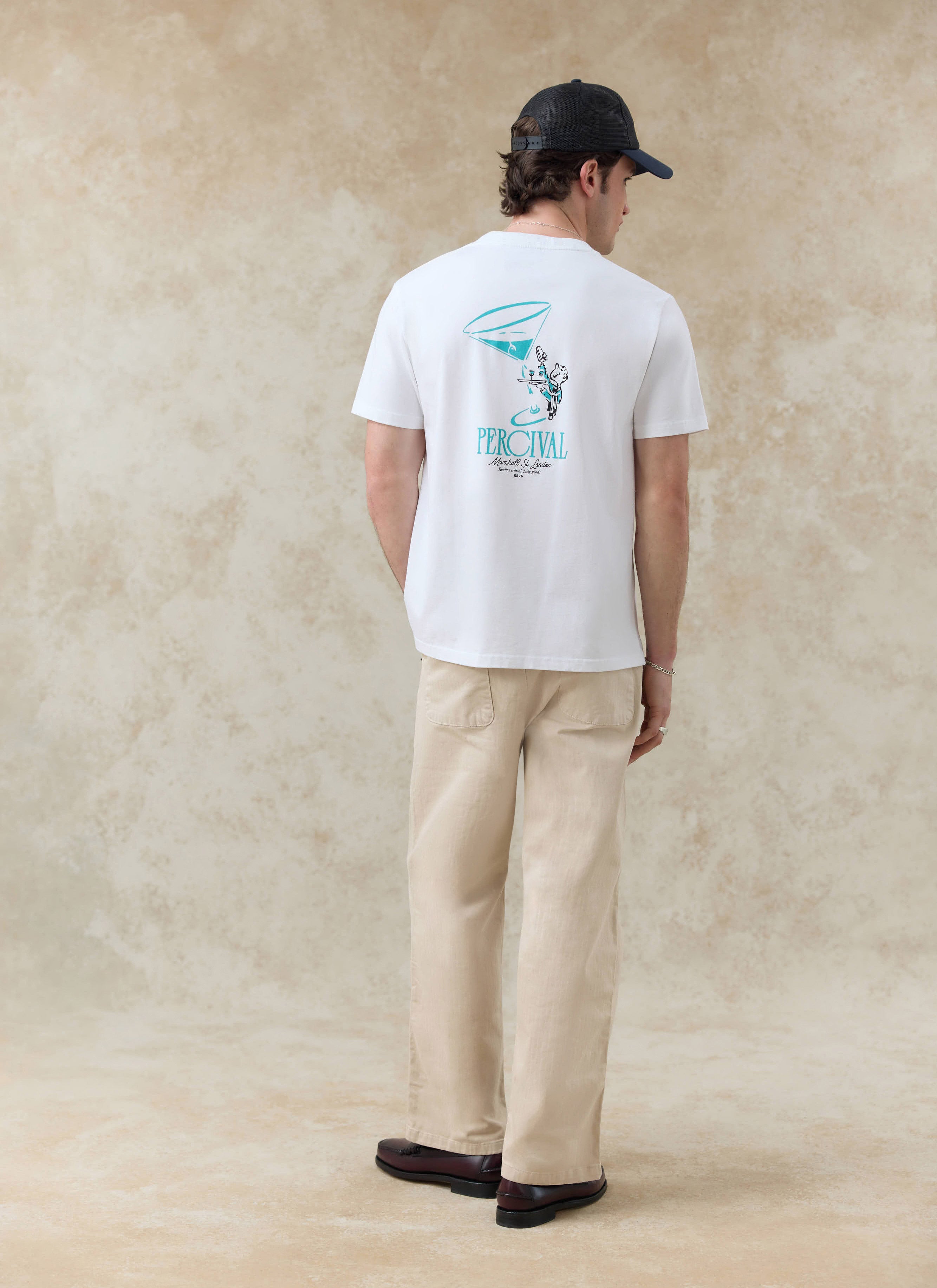 White Percival Walker T-shirt in organic cotton featuring a Martini glass back graphic, shown from behind on a model.
