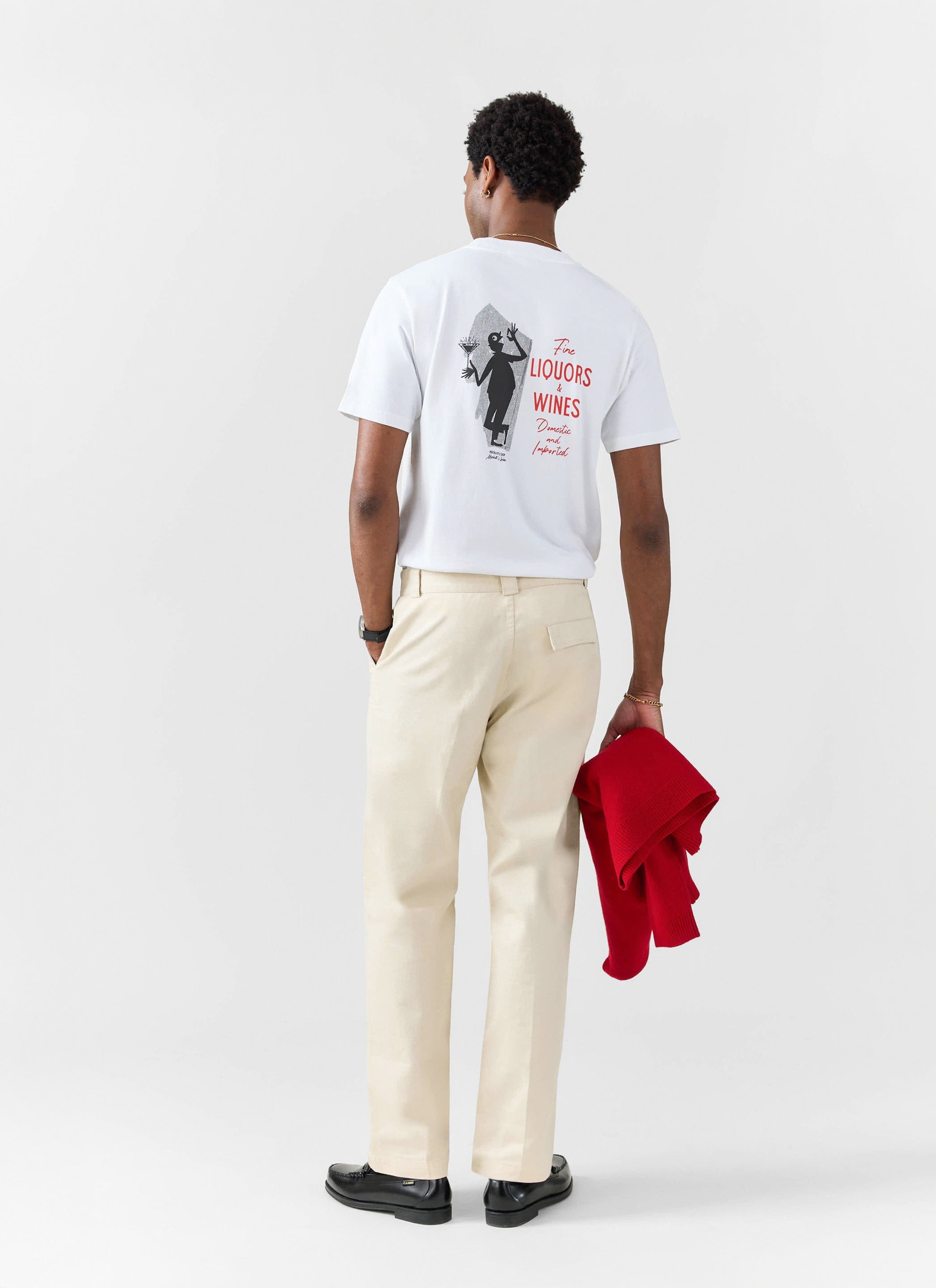 A model wears the white Percival Carlo Mixologist t-shirt, seen from behind to show the vintage-inspired back graphic.