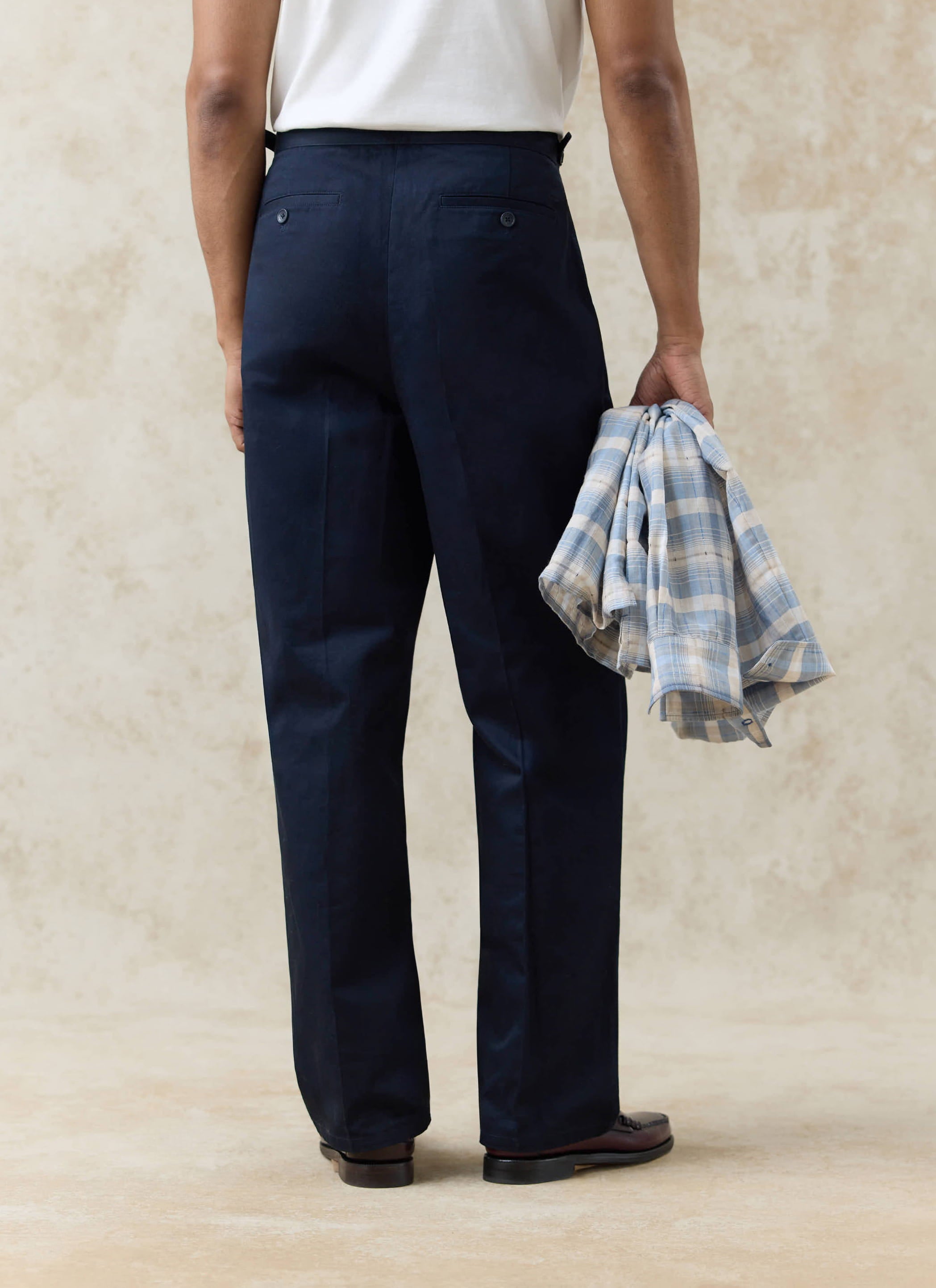 Rear view of Percival navy cotton Blake Double Pleated Trousers, featuring tailored back welt pockets and a clean fit.