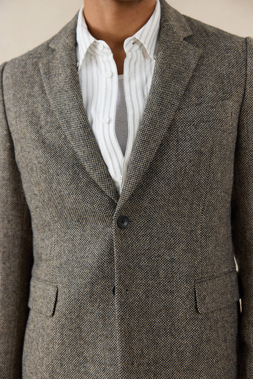 A close-up of the Percival Tailored Blazer in Birdseye Wool Grey, highlighting the textured micro-pattern of the fabric.
