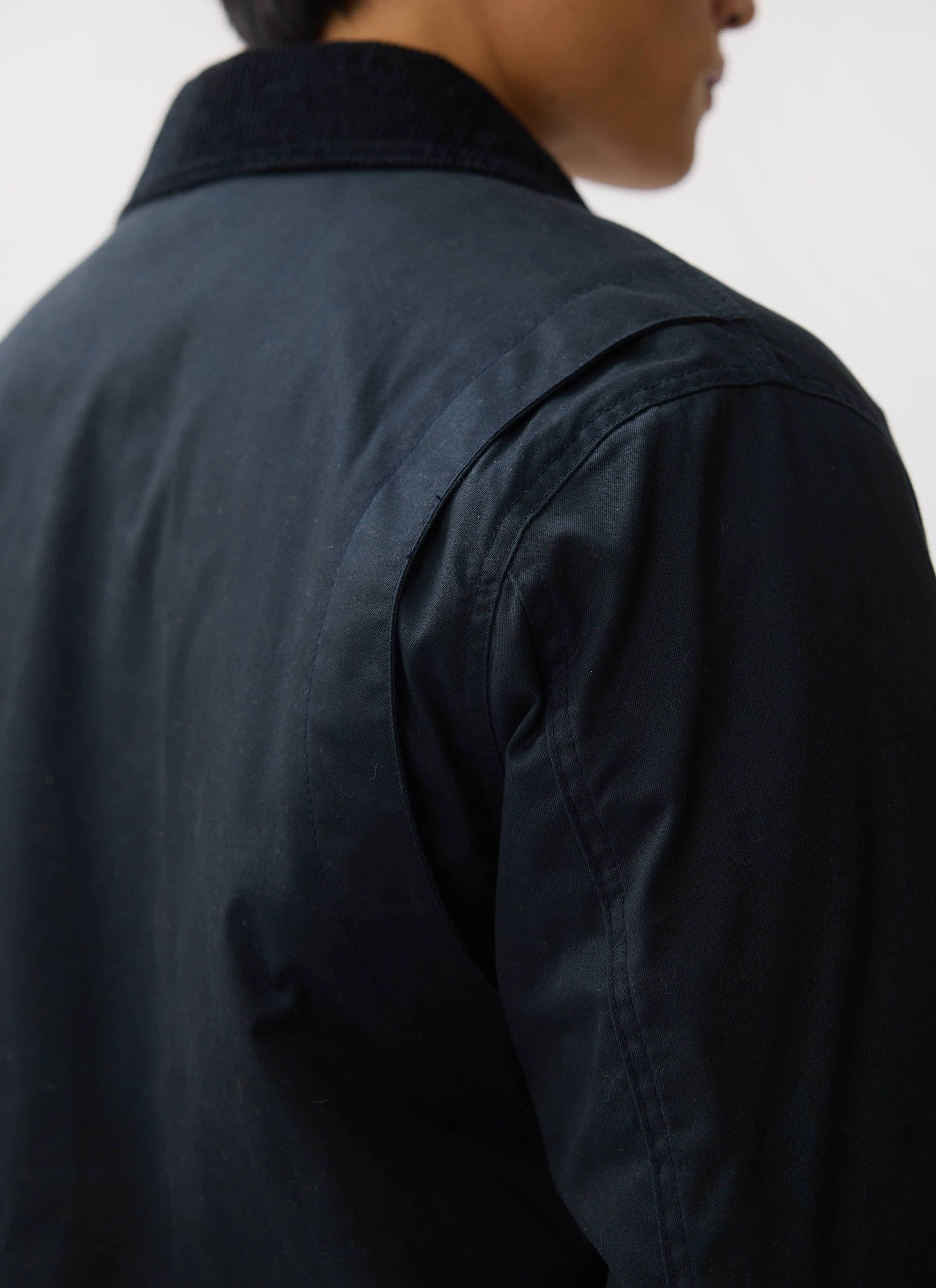 A close-up on the action back and corduroy collar of the Percival Fontane Wax Jacket in navy.