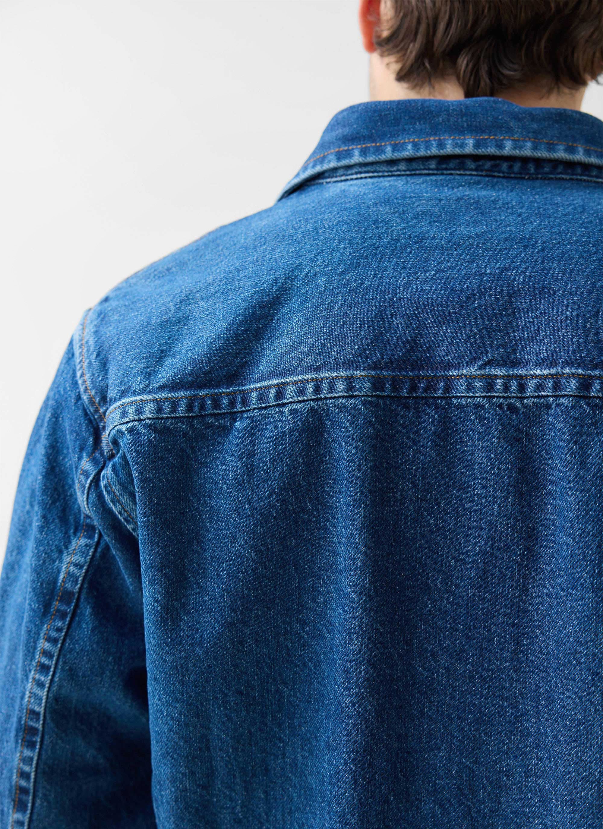 Close-up on the back yoke and collar of the Percival Denim Heavyweight Overshirt in a mid-wash blue.