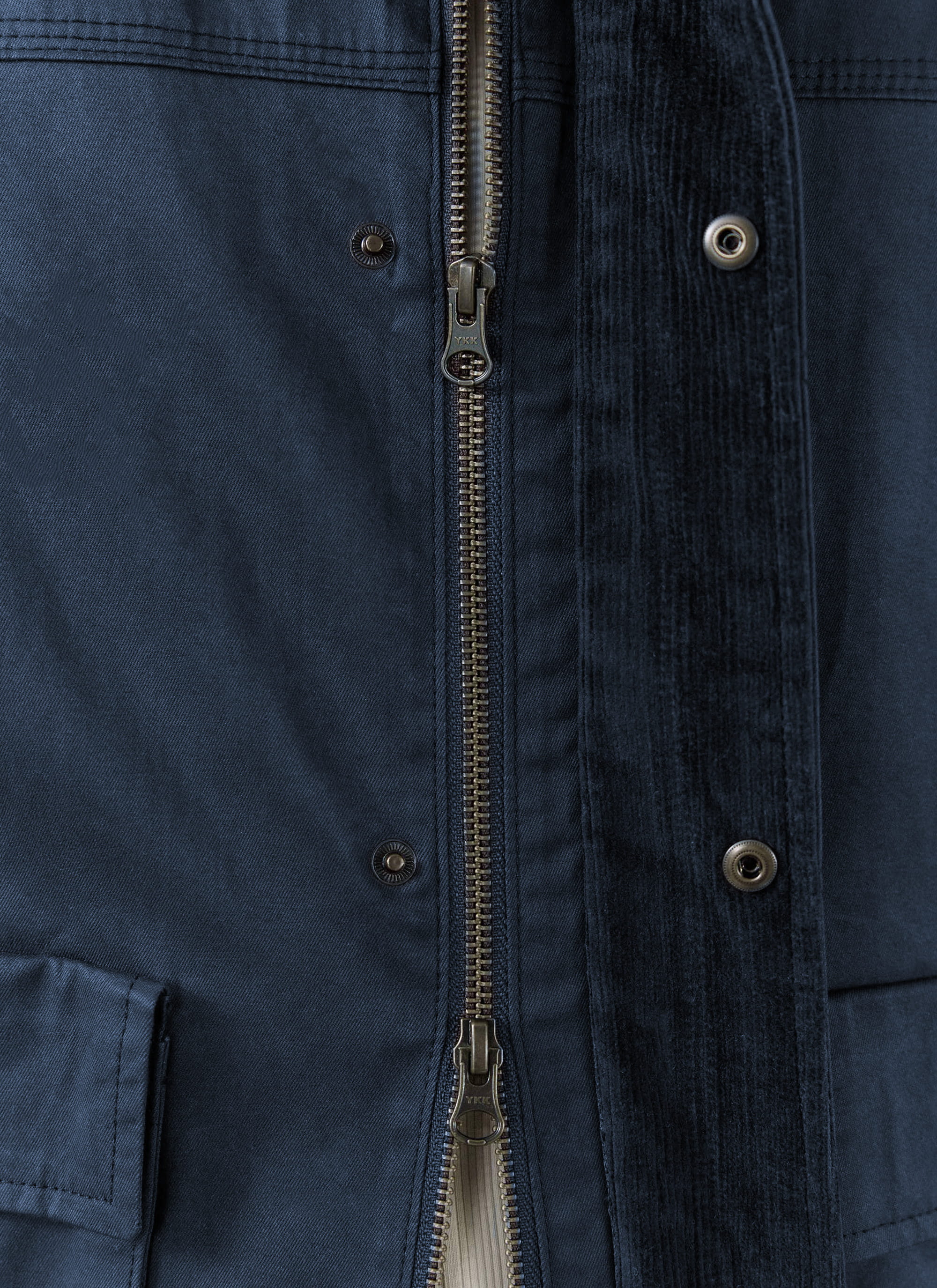 Close-up of the metal zip and snap fastenings on the navy blue waxed cotton Percival Wax Zip Jacket.