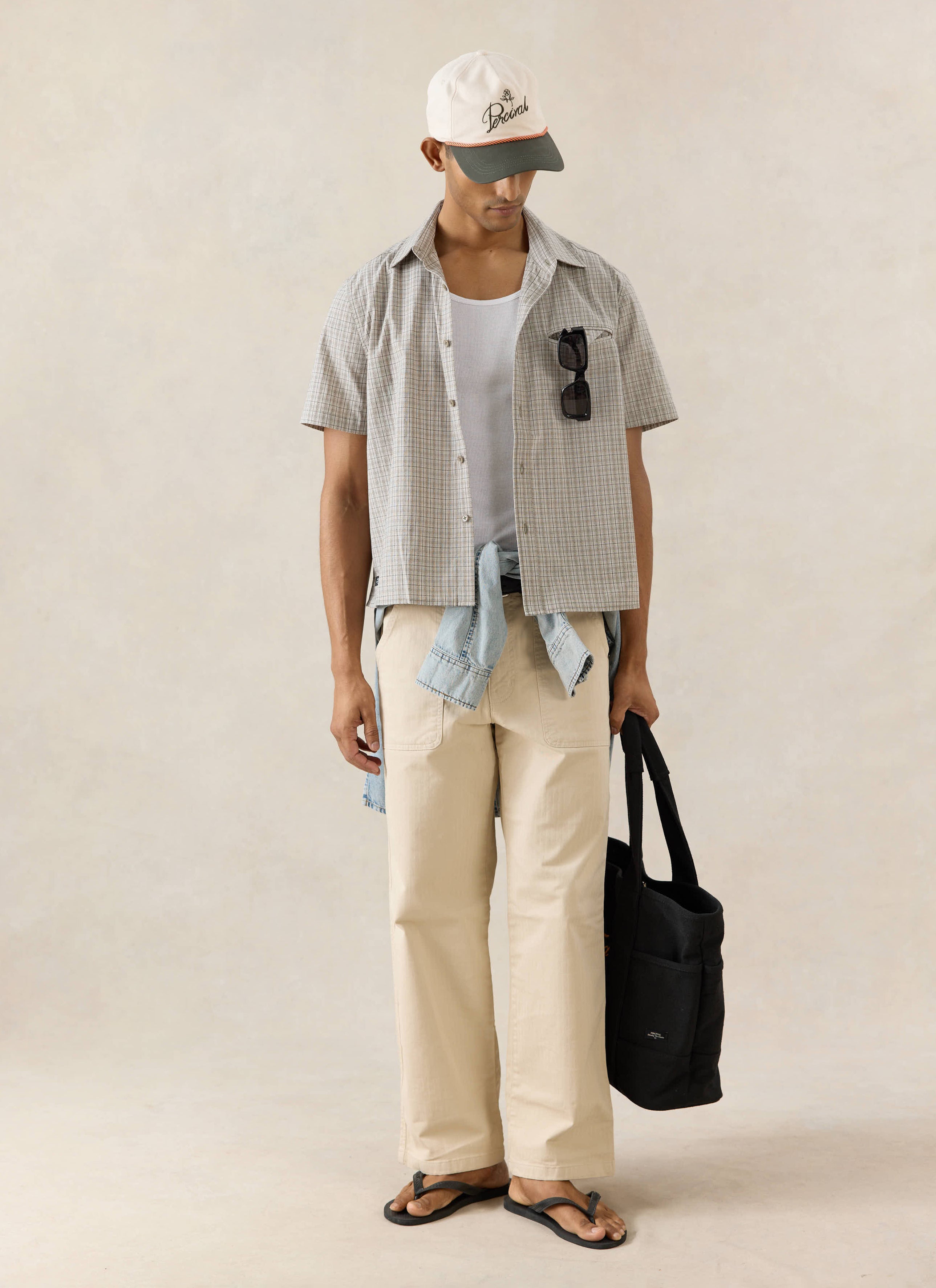 The Percival Hinsley short sleeve boxy cotton shirt in cream check, styled with a Spencer cap and Lucas trousers.