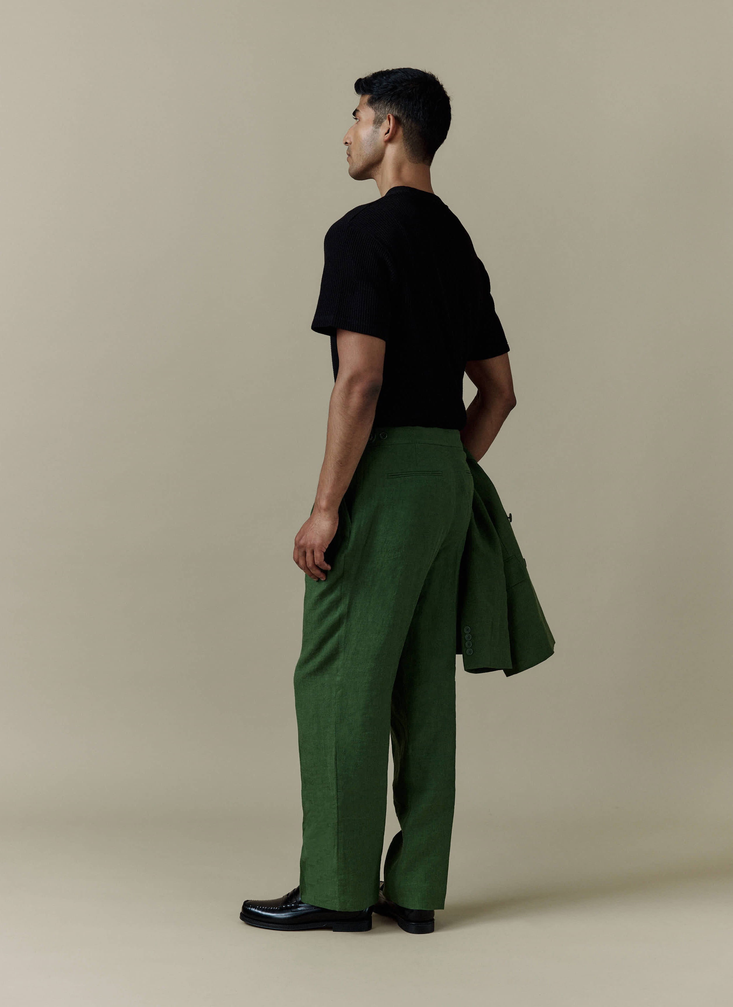 Percival pleated tailored linen trousers in forest green, styled on a model with a matching blazer.