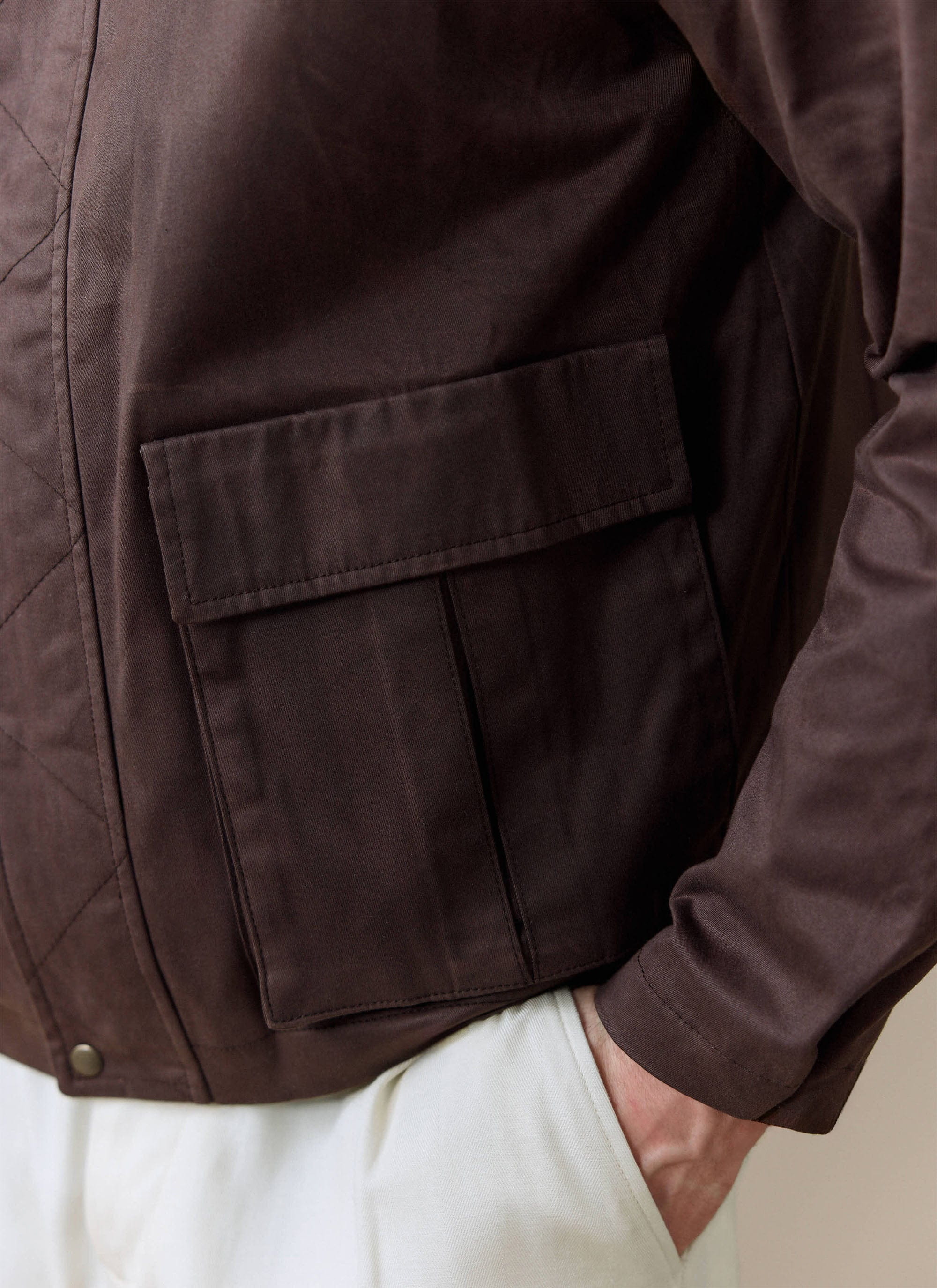 Close-up of the patch pocket detail on the espresso brown Percival cotton wax zip jacket.