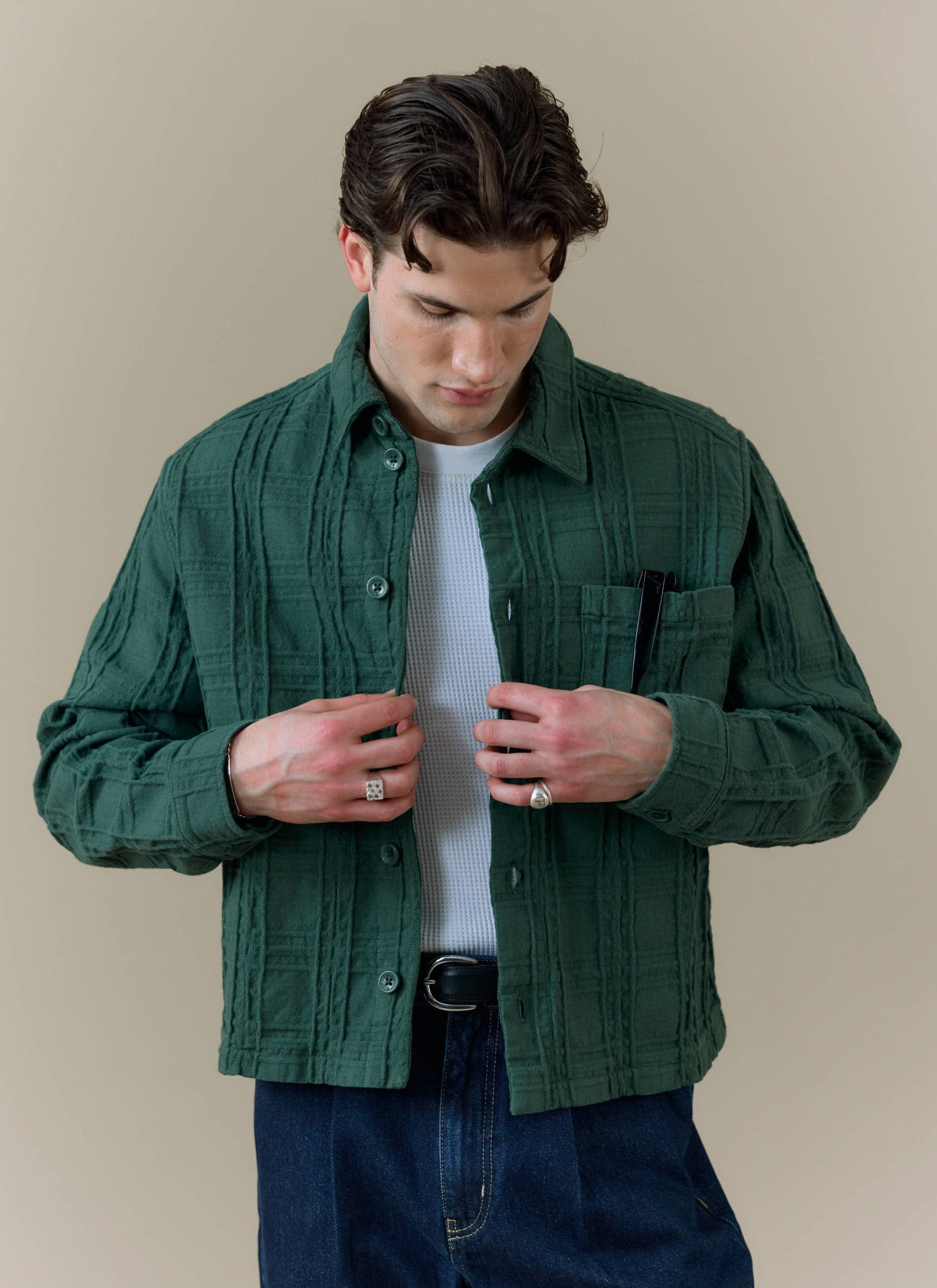Model wearing the Percival Canyon Heavyweight Overshirt in forest green, showing the textured woven cotton fabric.