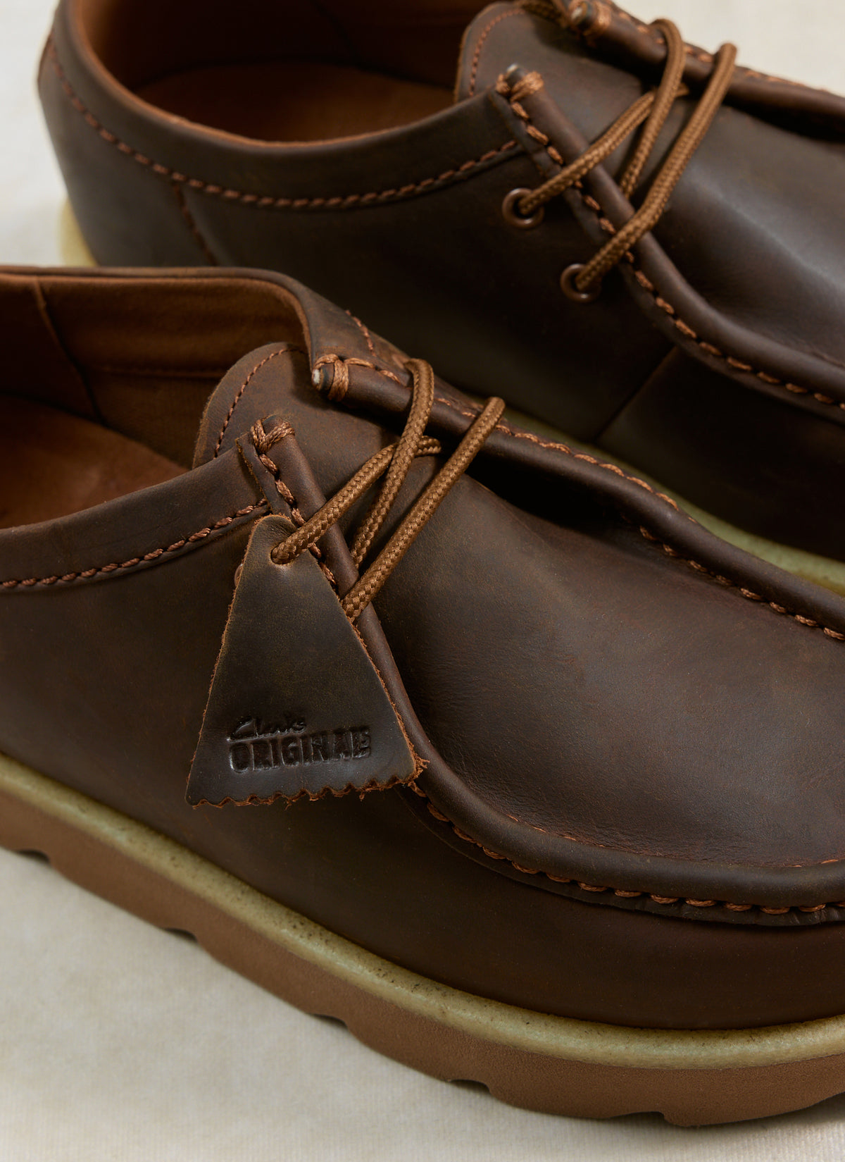 A close-up of the Clarks Originals Meare Walla Shoes in beeswax brown leather, highlighting the signature fob and stitching.