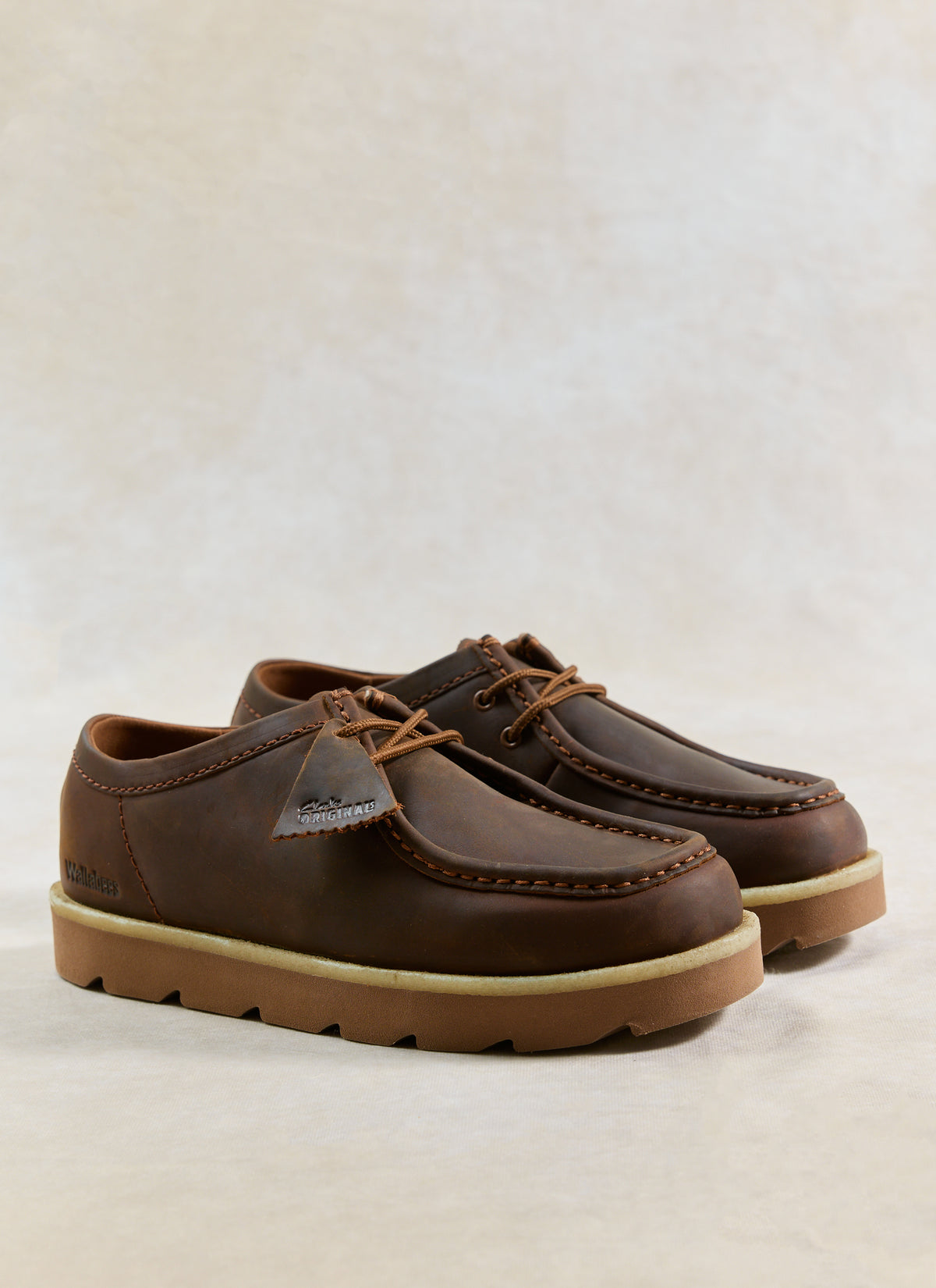 Clarks Originals Meare Walla shoes in beeswax brown leather, showing the signature moccasin stitching and crepe sole.