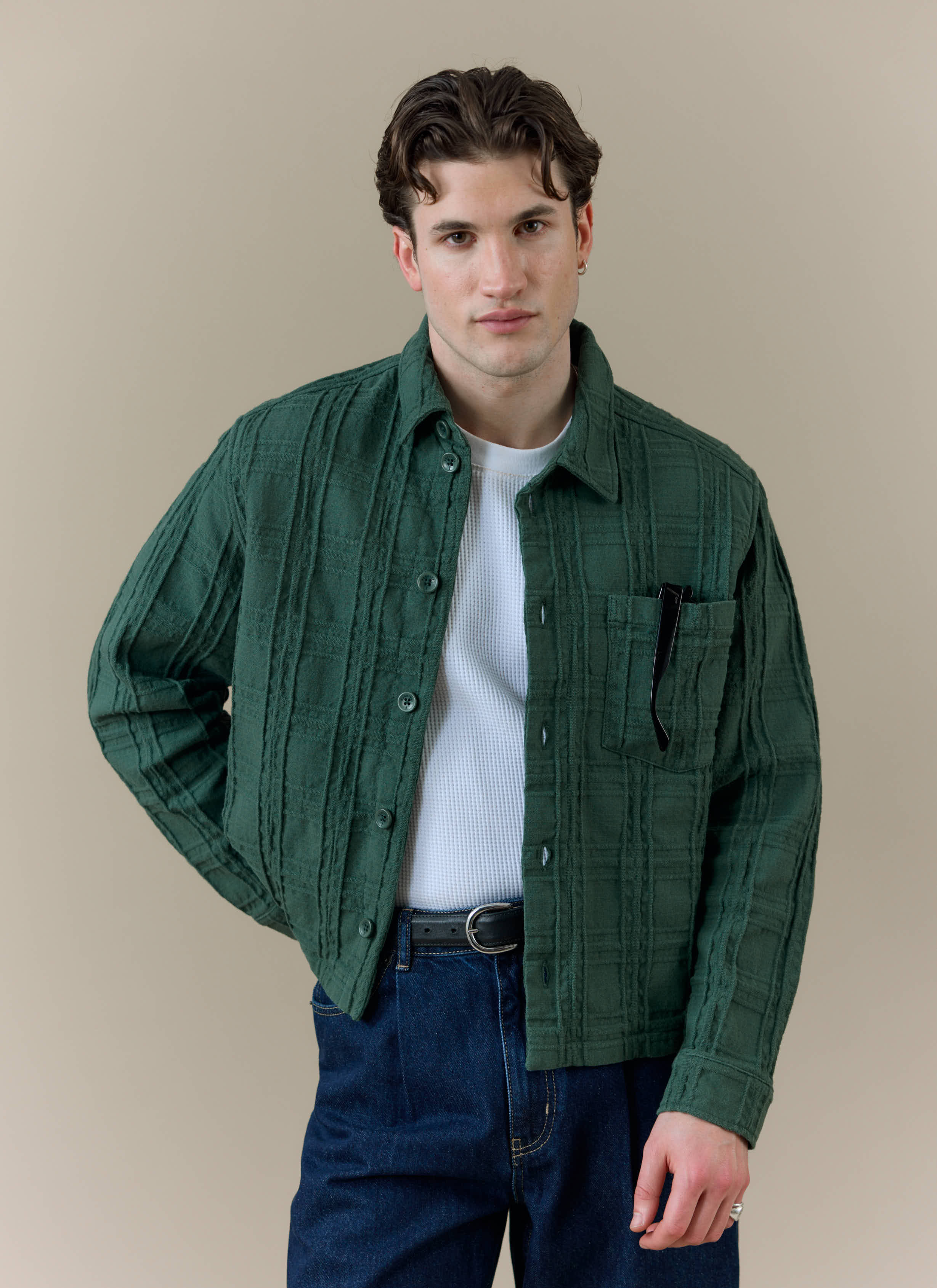 Model wearing the forest green Percival Canyon Heavyweight Overshirt over a white t-shirt and dark jeans.