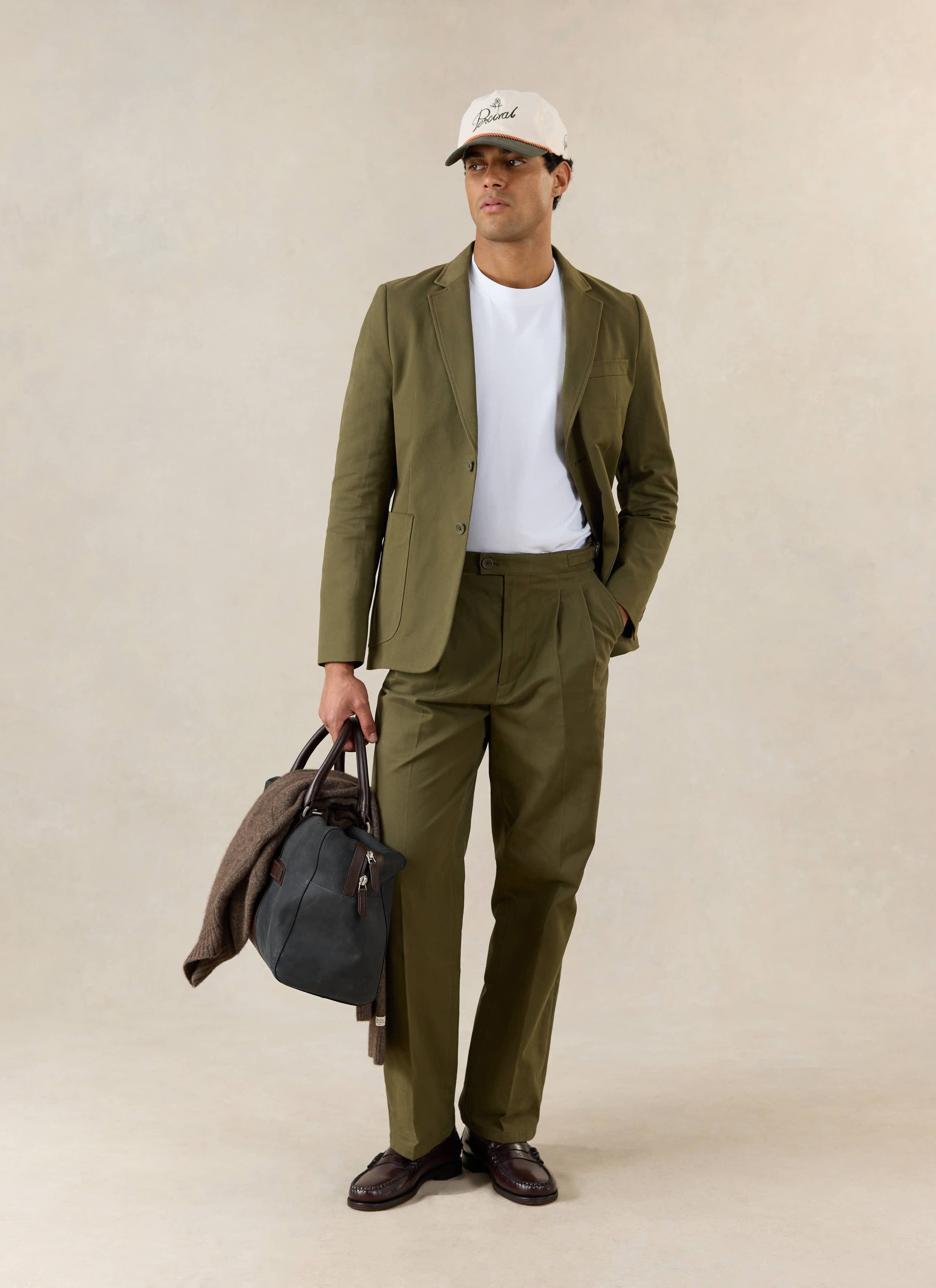 A model wears the Percival Tailored Blazer and Percival Blake Double Pleated Tailored Trousers in Forest Brushed Moleskin.