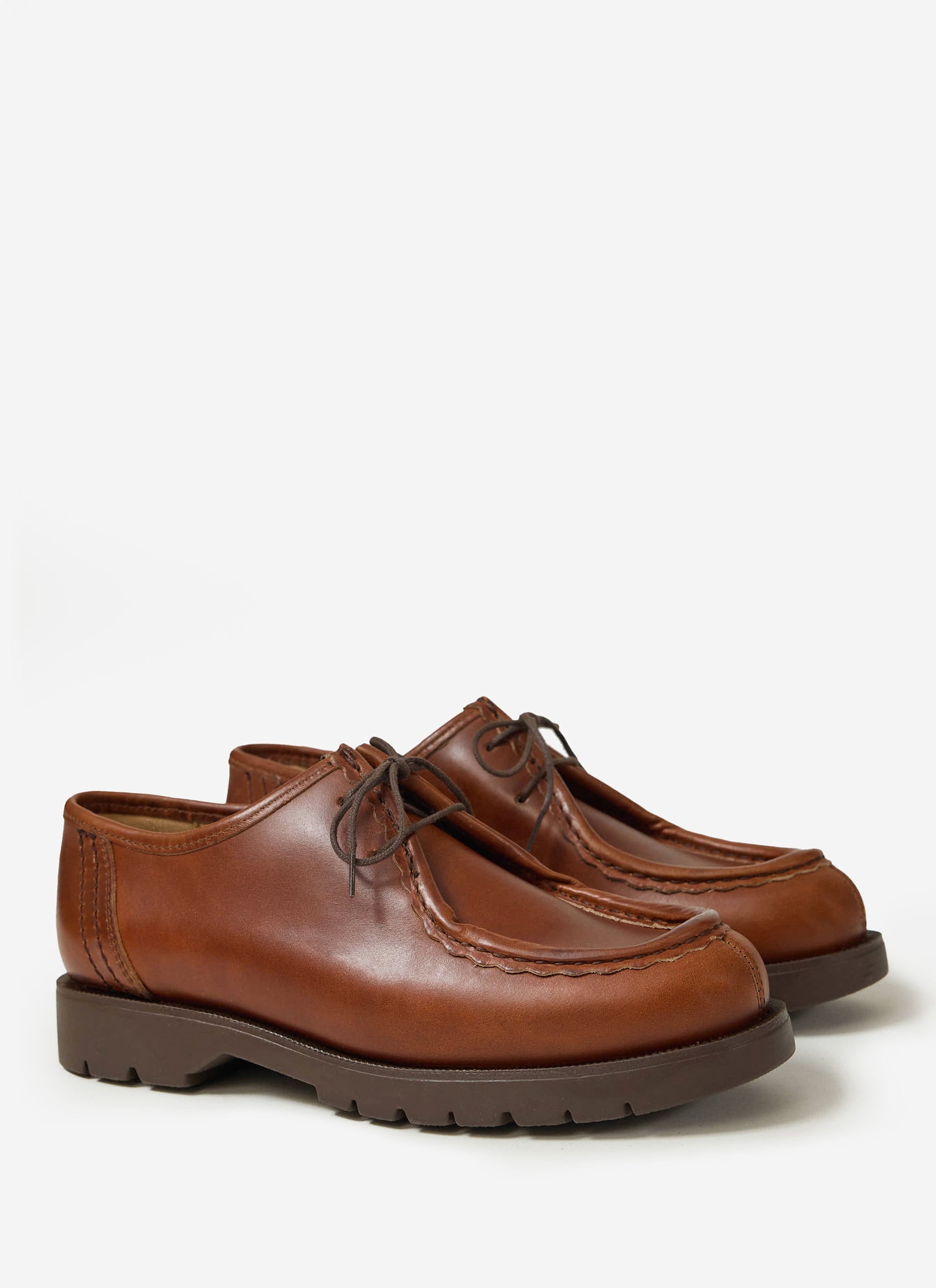 A pair of Percival's Kleman Padror TH shoes in cognac leather, with their signature serrated hem, on a white background.