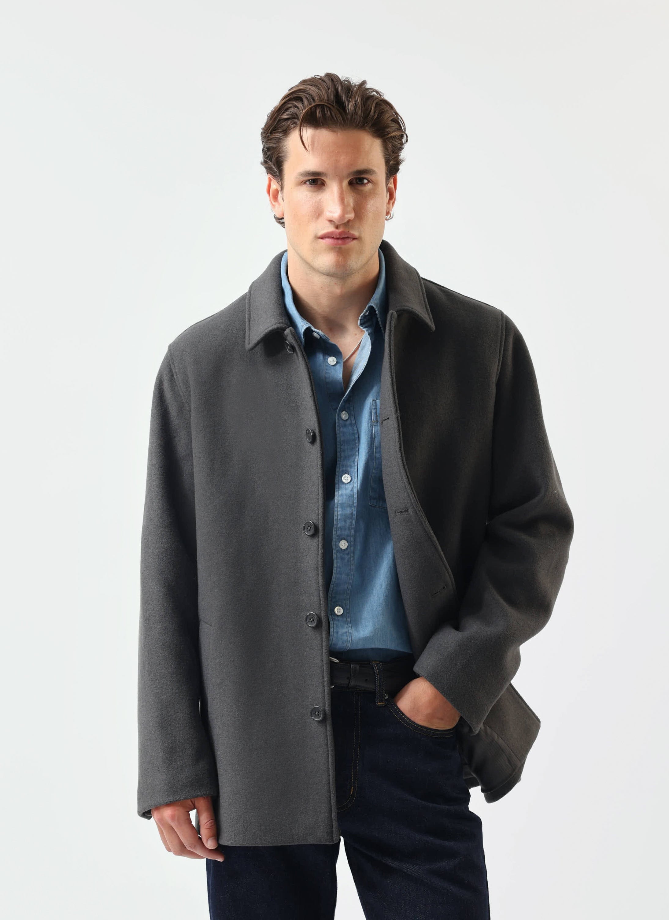 A model wears the Percival Melton Wool Peacoat in charcoal over a denim shirt against a white background.