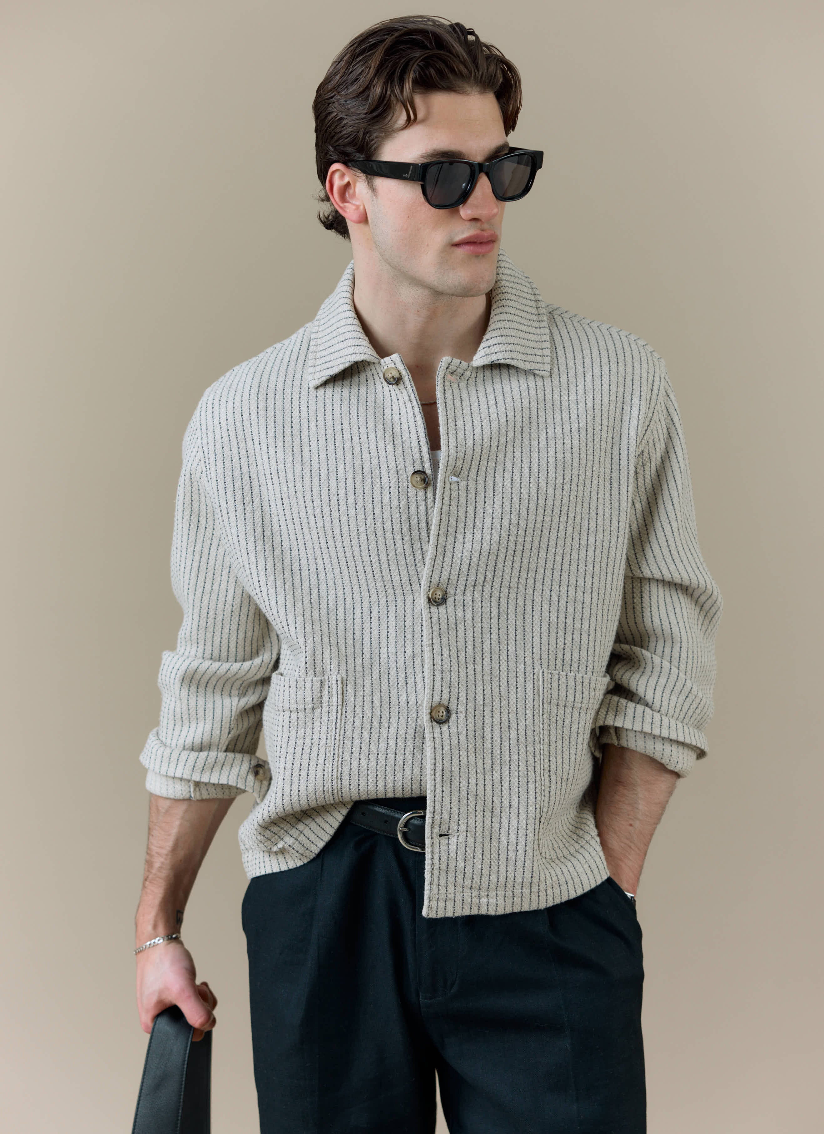Model wearing the Percival Sorrento Boxy Overshirt in cream linen, featuring a vertical textured weave.