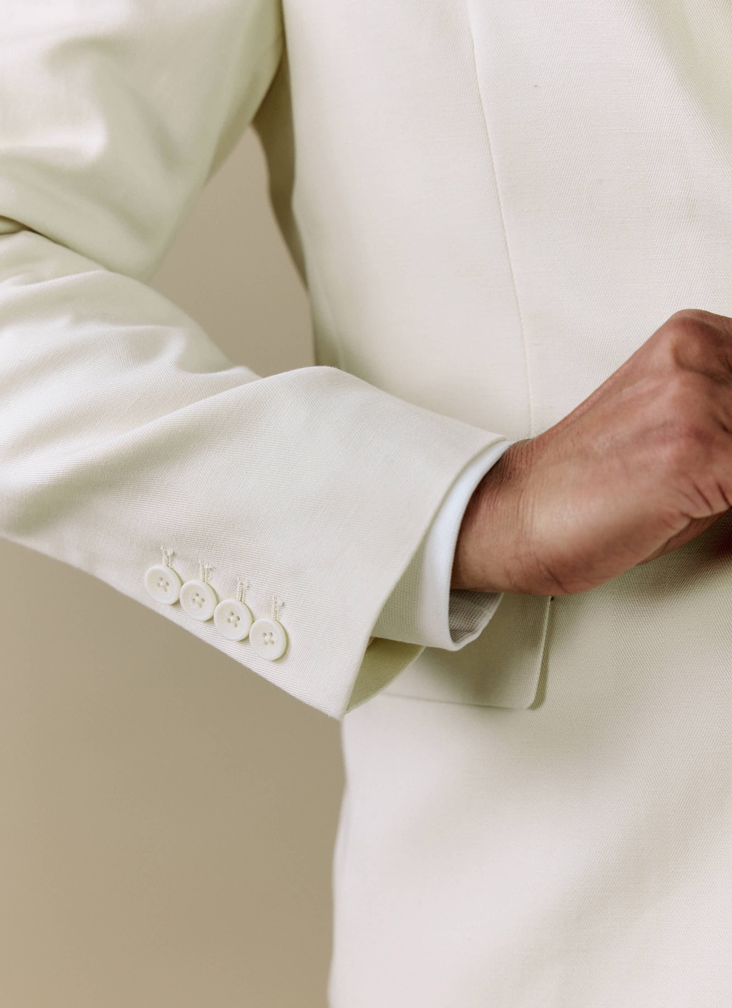 Close-up of the sleeve and four-button cuff on the cream Clifton 3 Button Blazer by Percival.