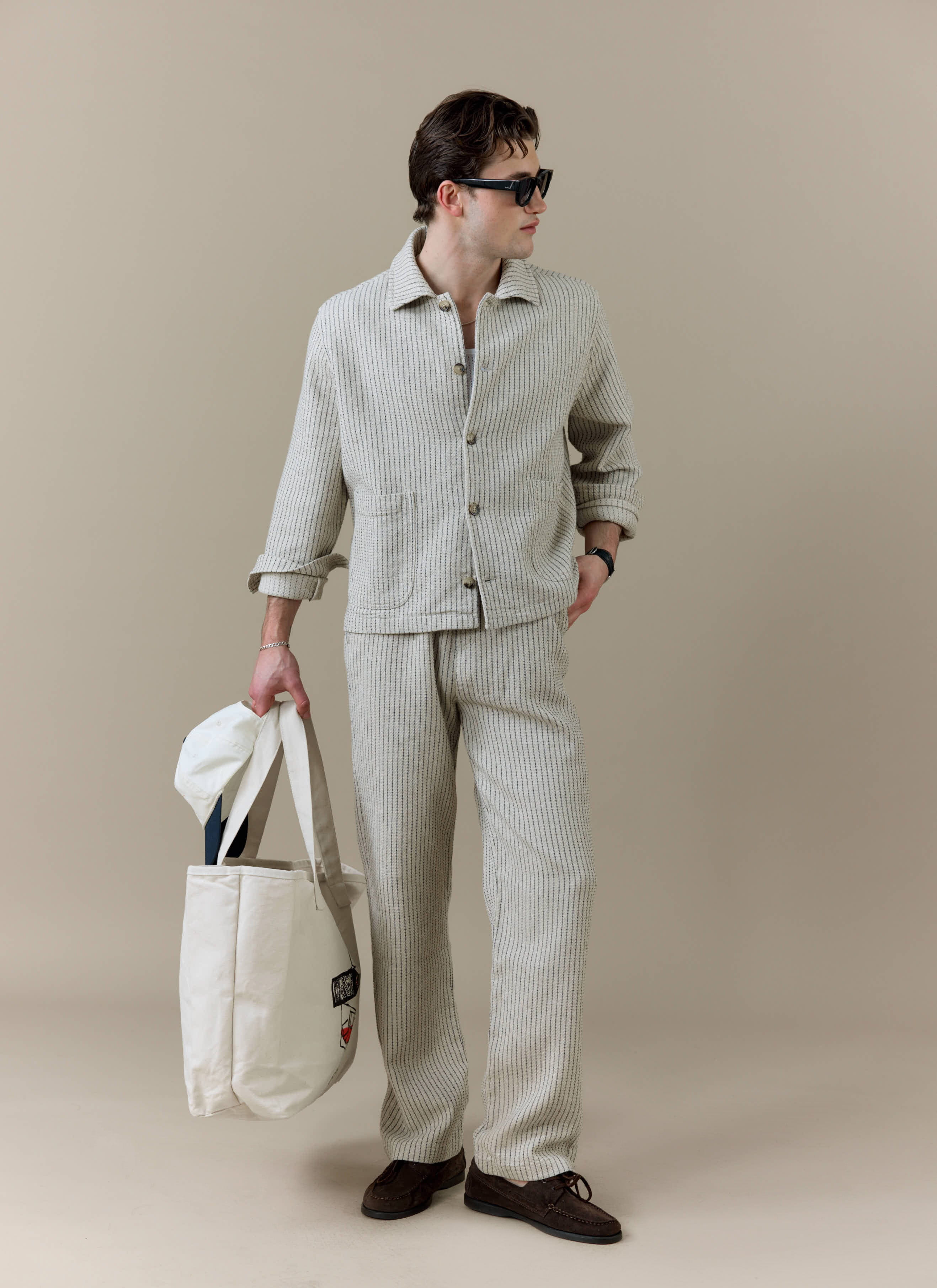Model wearing the Percival Sorrento Boxy Overshirt and Wide Leg Trousers in cream textured linen as a co-ord set.