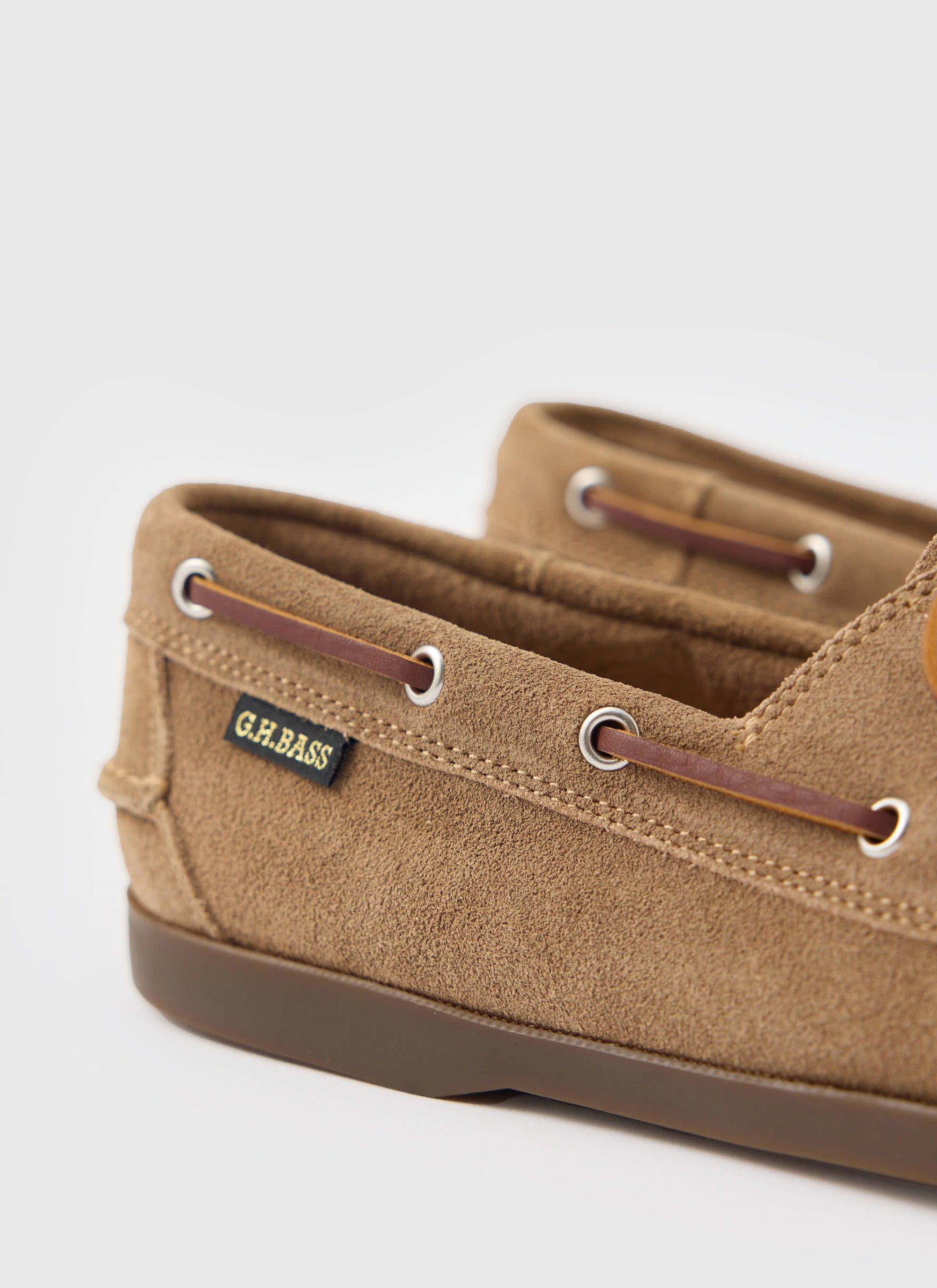 A close-up of the heel of the Percival G.H. Bass Jetty II Boater shoe in earth suede, showing the woven brand label.