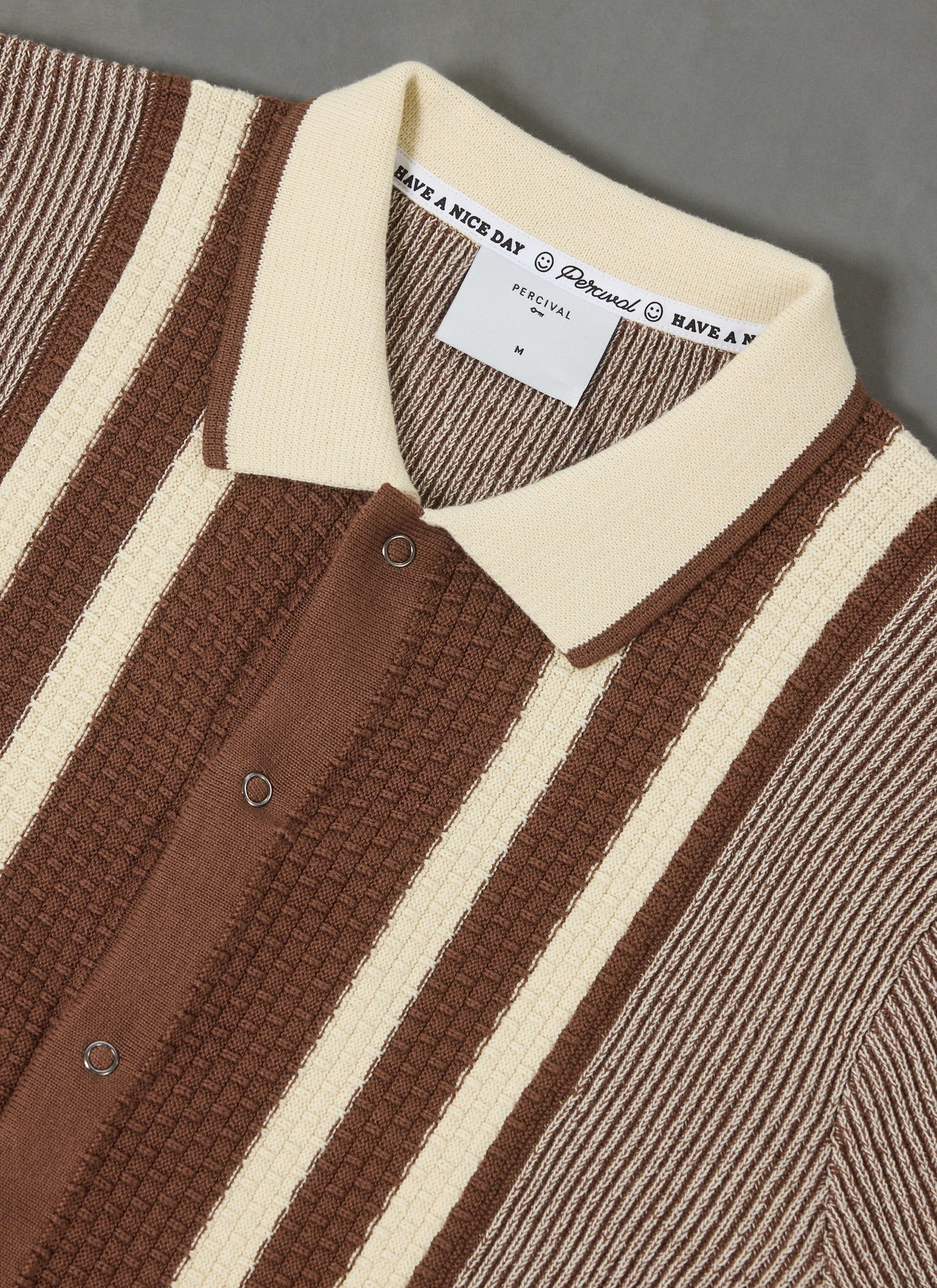 A close-up of the Percival Teramo Knitted Polo Shirt in ecru and brown stripes, highlighting the textured knit and collar.