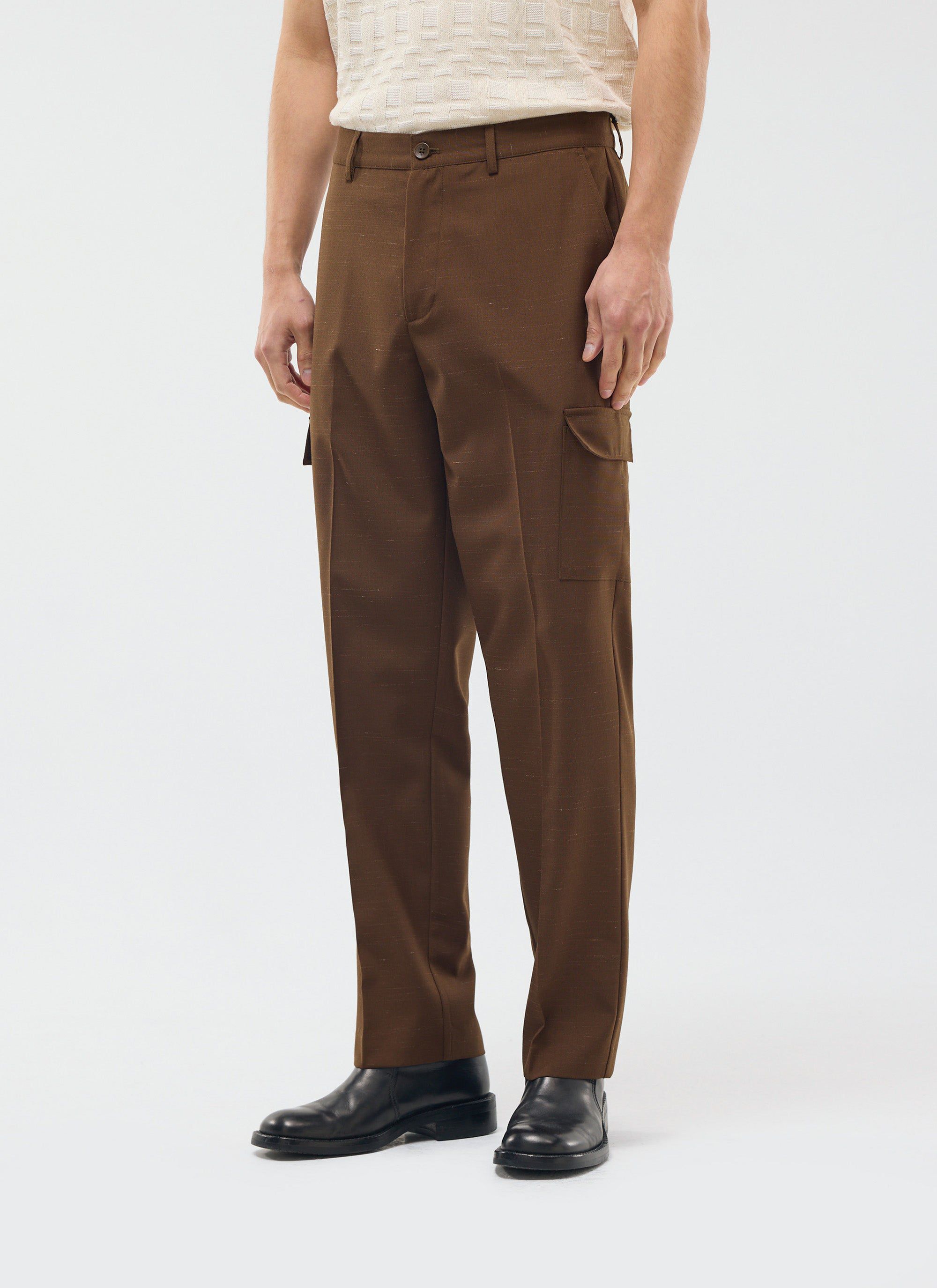A model wears the brown Percival Trentino Tailored Patch Pocket Trousers with a cream knitted top and black leather shoes.