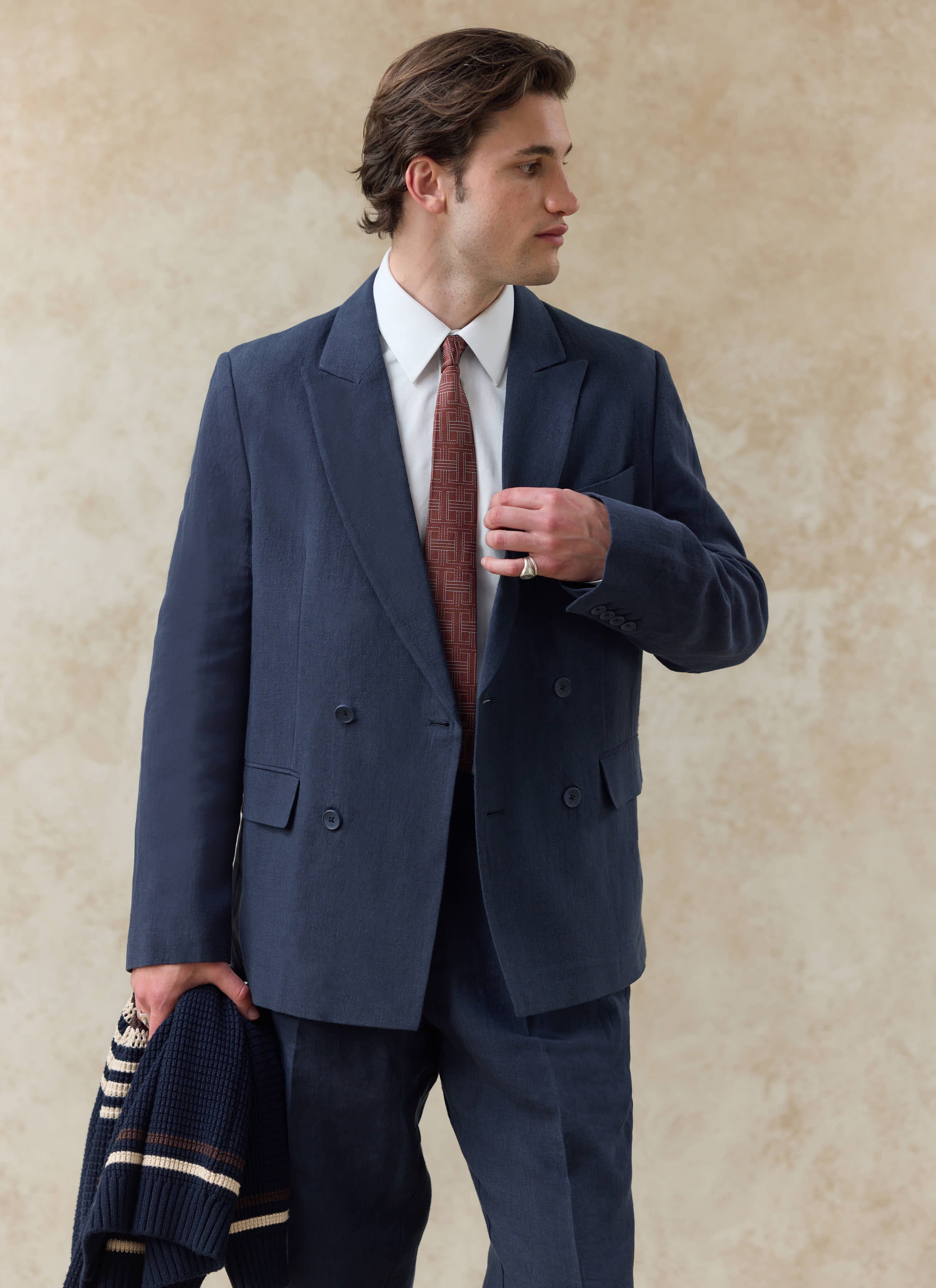 Navy blue linen Percival Clifton double breasted blazer, styled with a white shirt and patterned tie.