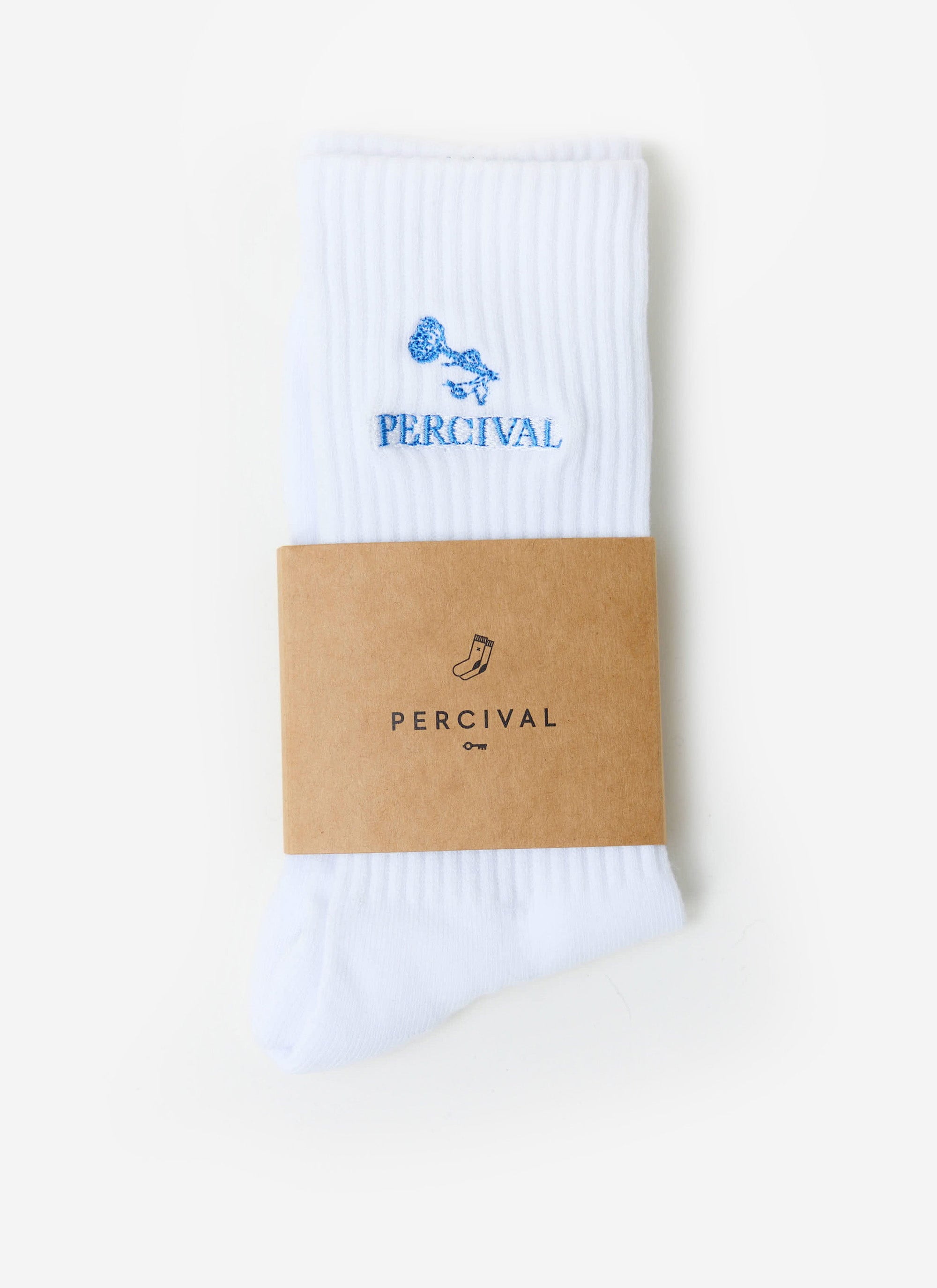 The white Percival Smith Floral socks, featuring blue floral embroidery, folded neatly within their branded cardboard sleeve.