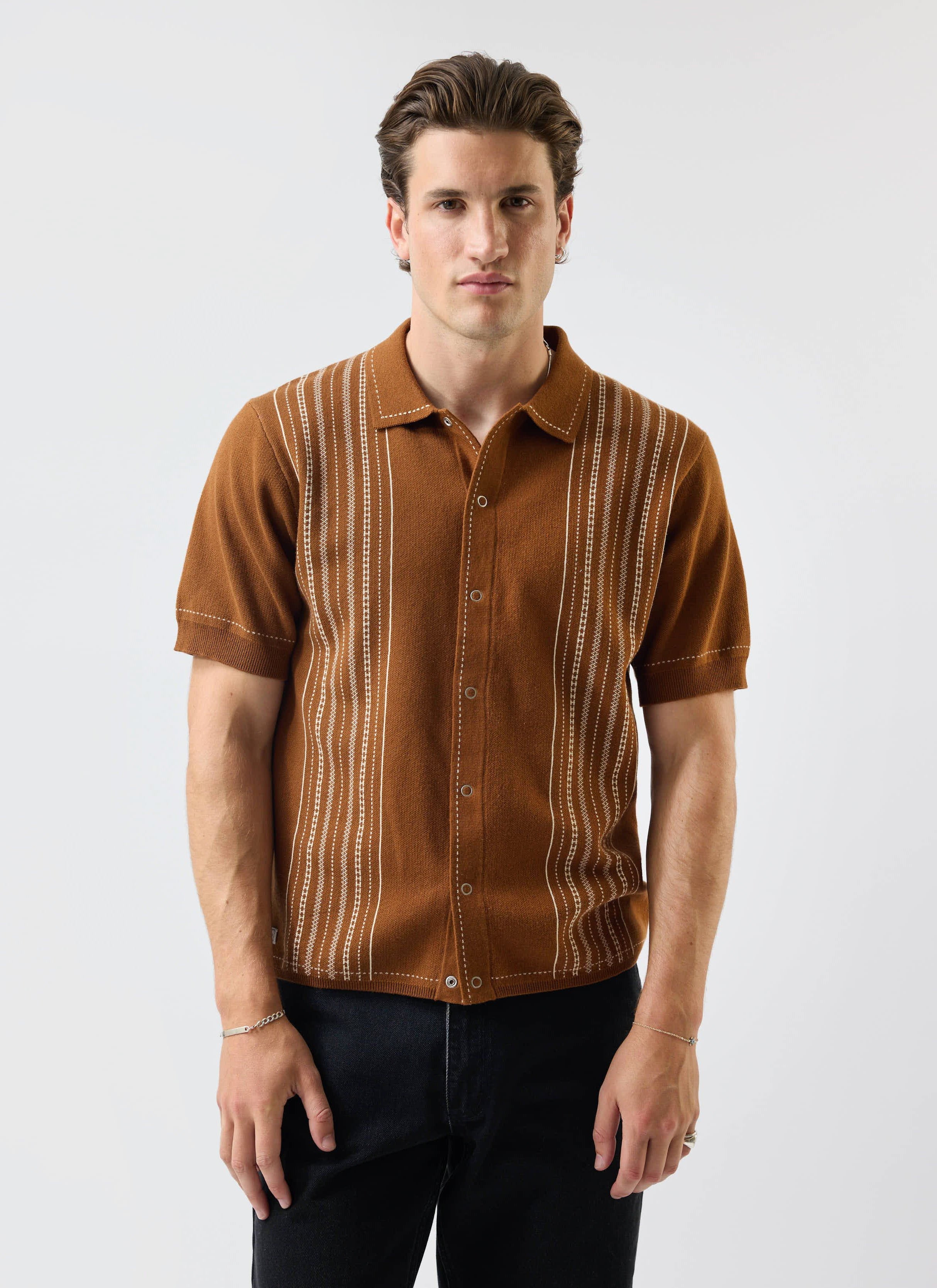 A model wears the Percival Accolades Knitted Short Sleeve Shirt in tobacco brown against a plain white studio background.