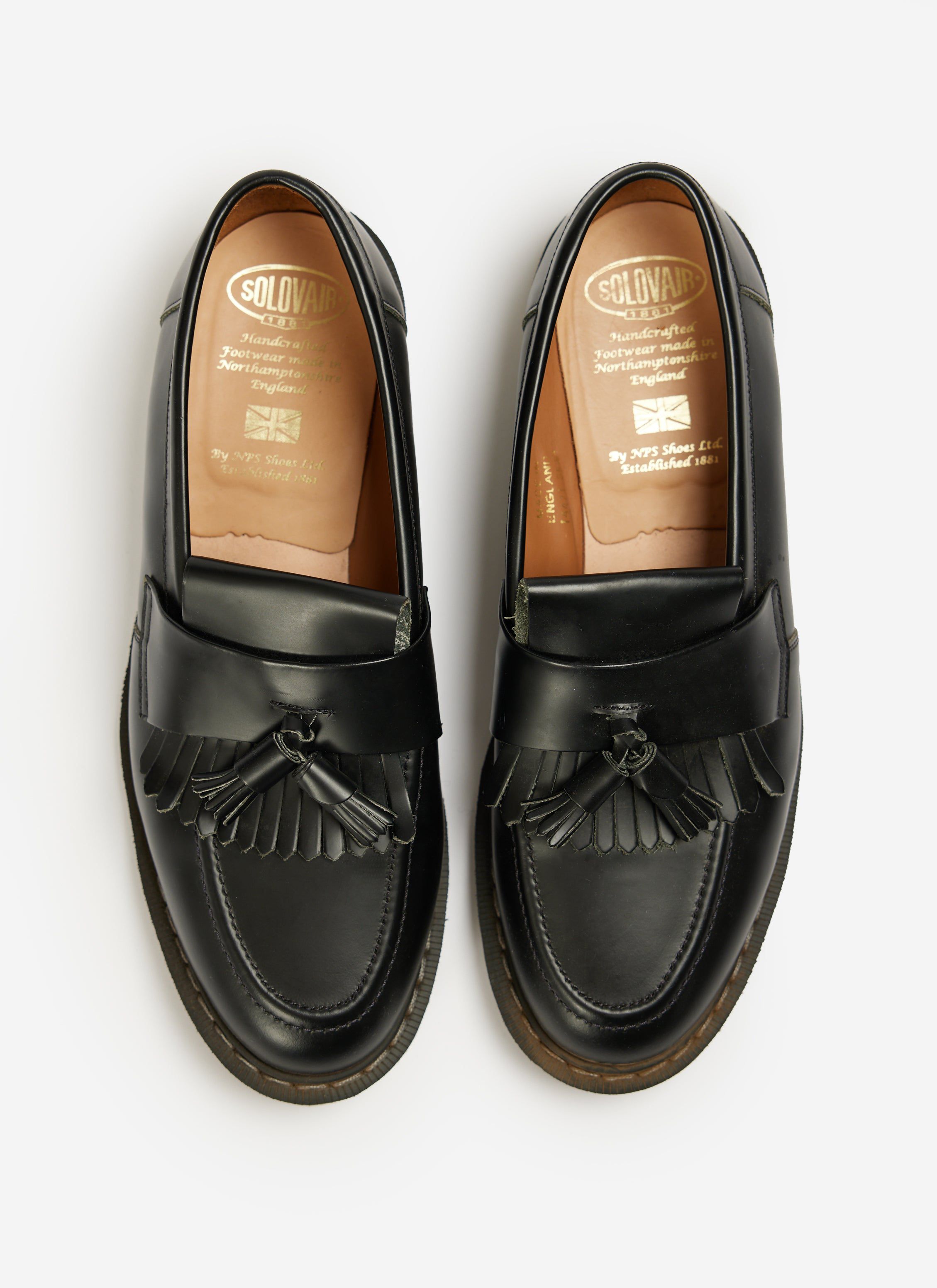 Top-down view of the Percival Solovair hi-shine black leather tassel loafers against a white background.