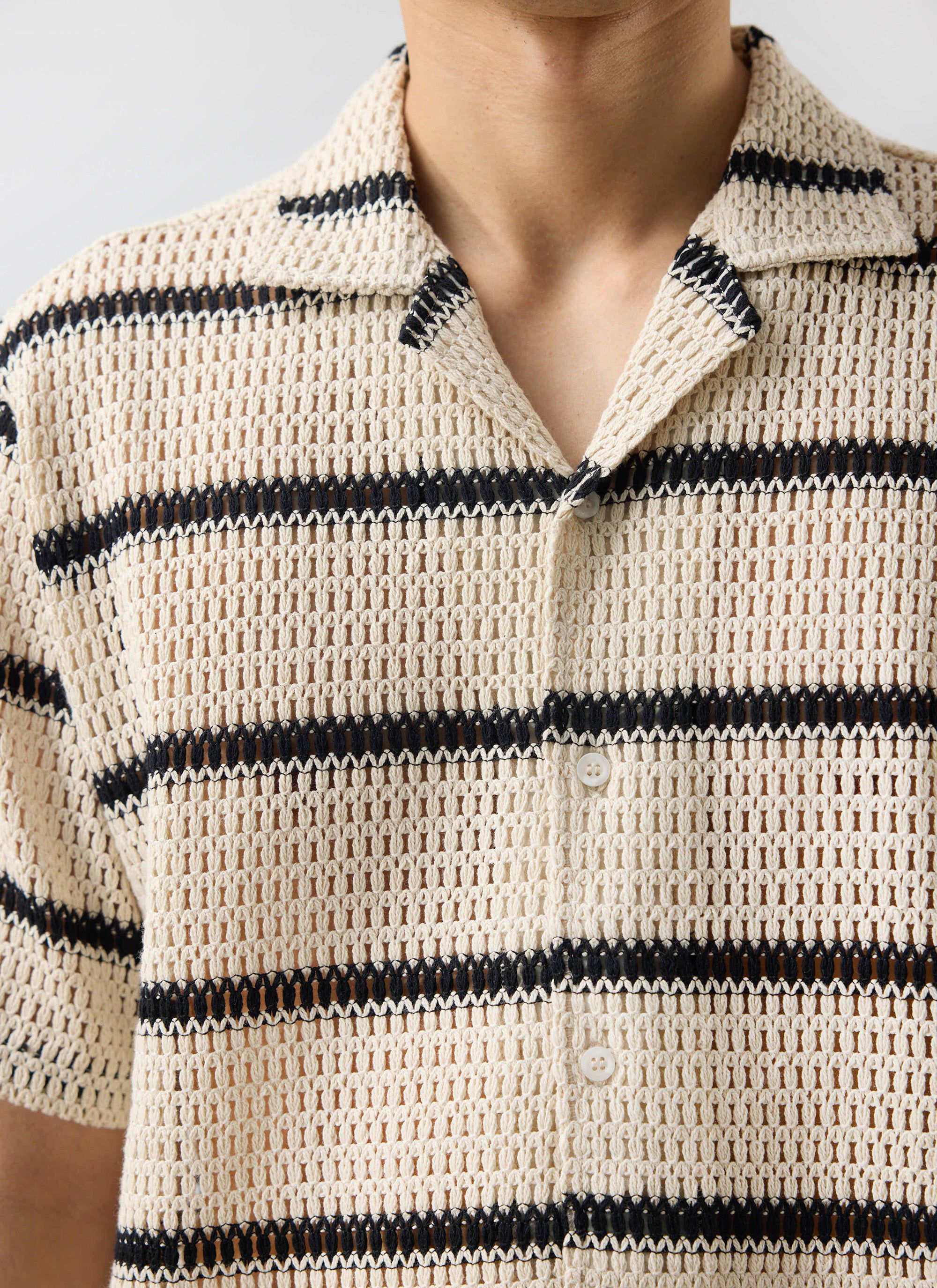 Close-up of the Percival Crochet Groundsman Cuban Shirt, highlighting its ecru and black striped crochet knit design.