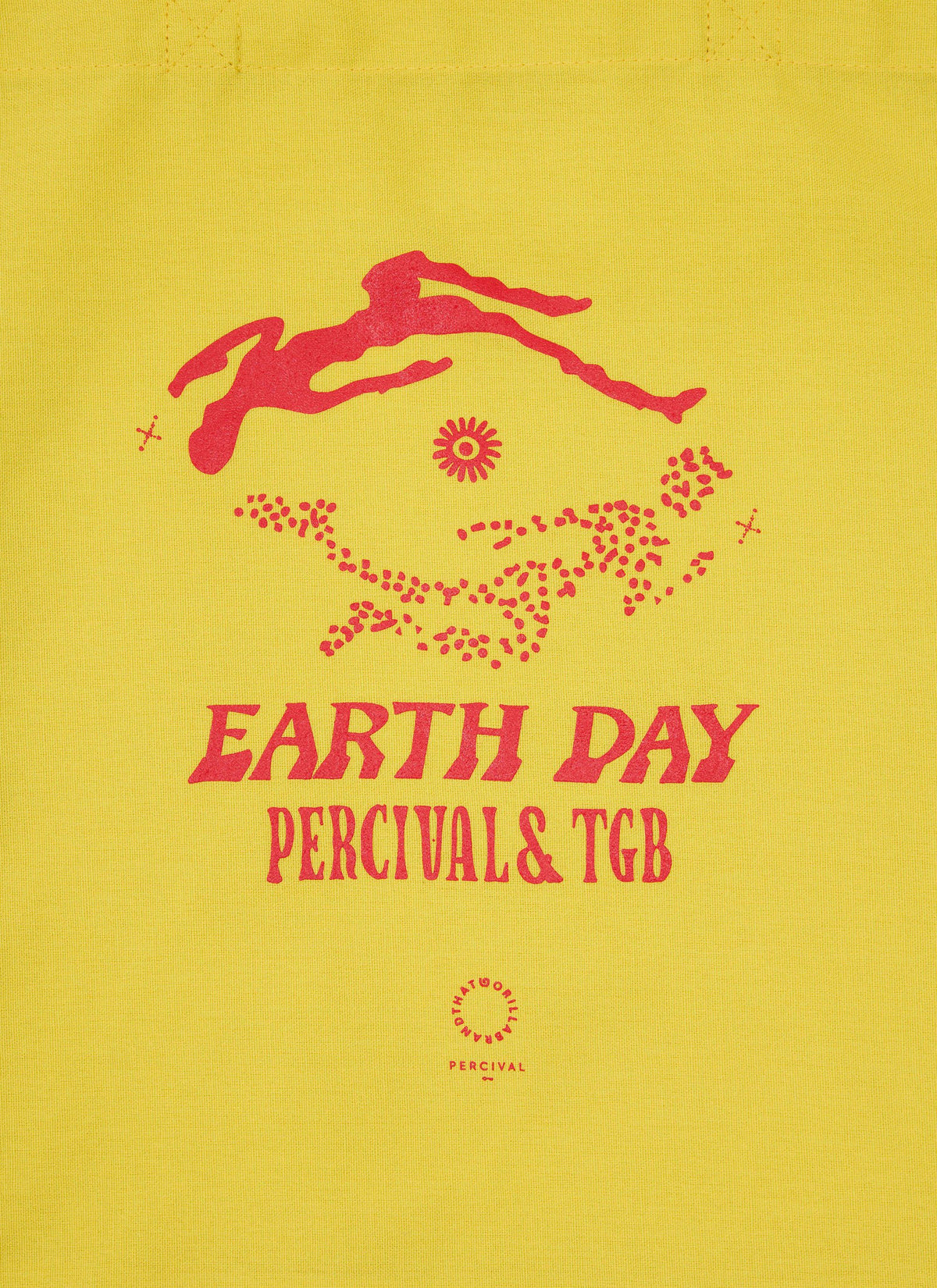 A close-up of the yellow Percival x The Gorilla Brand tote bag, highlighting the red 'Earth Day' collaborative print.