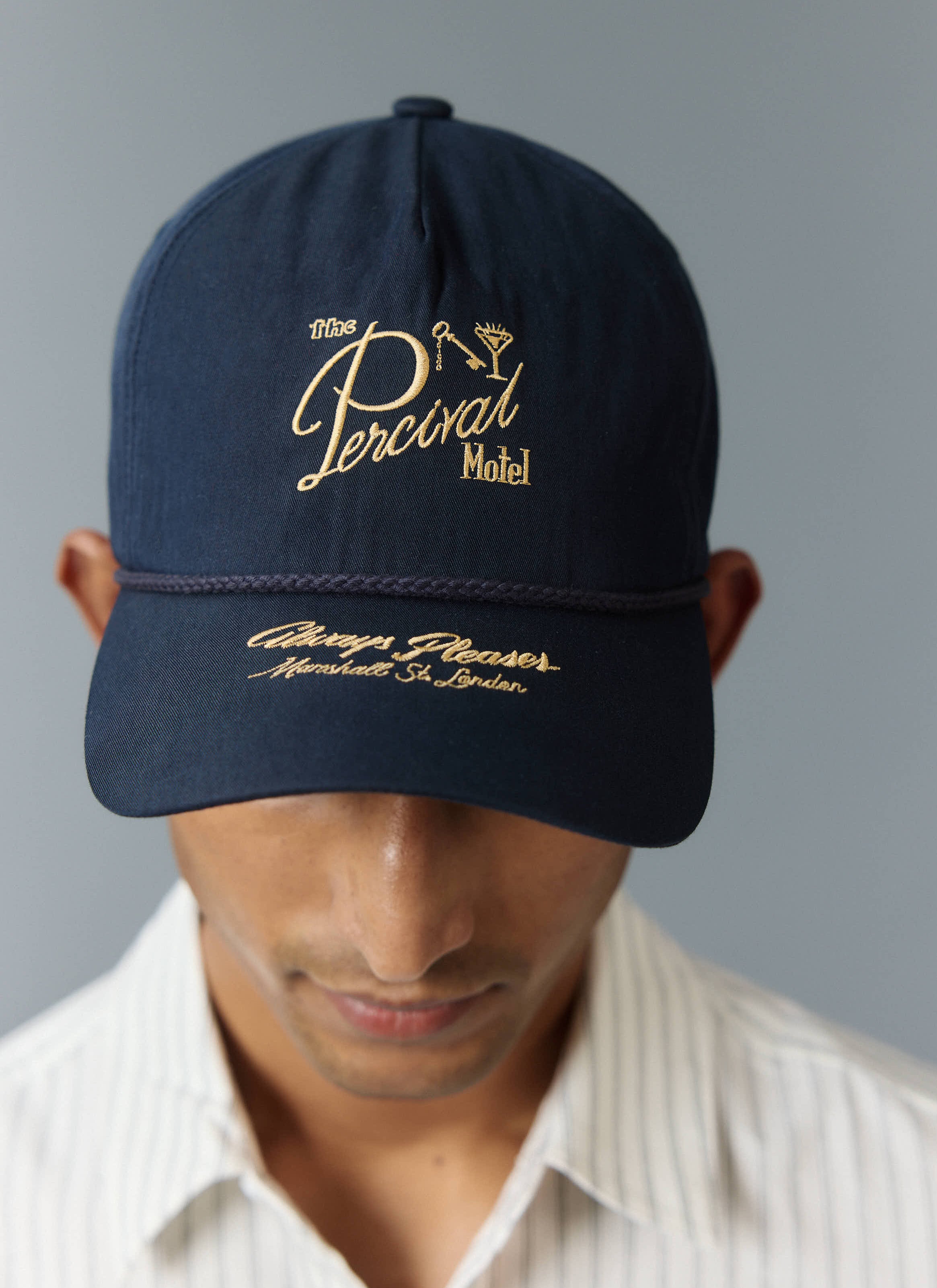 Percival's navy blue Kingsley cap with golden yellow embroidery