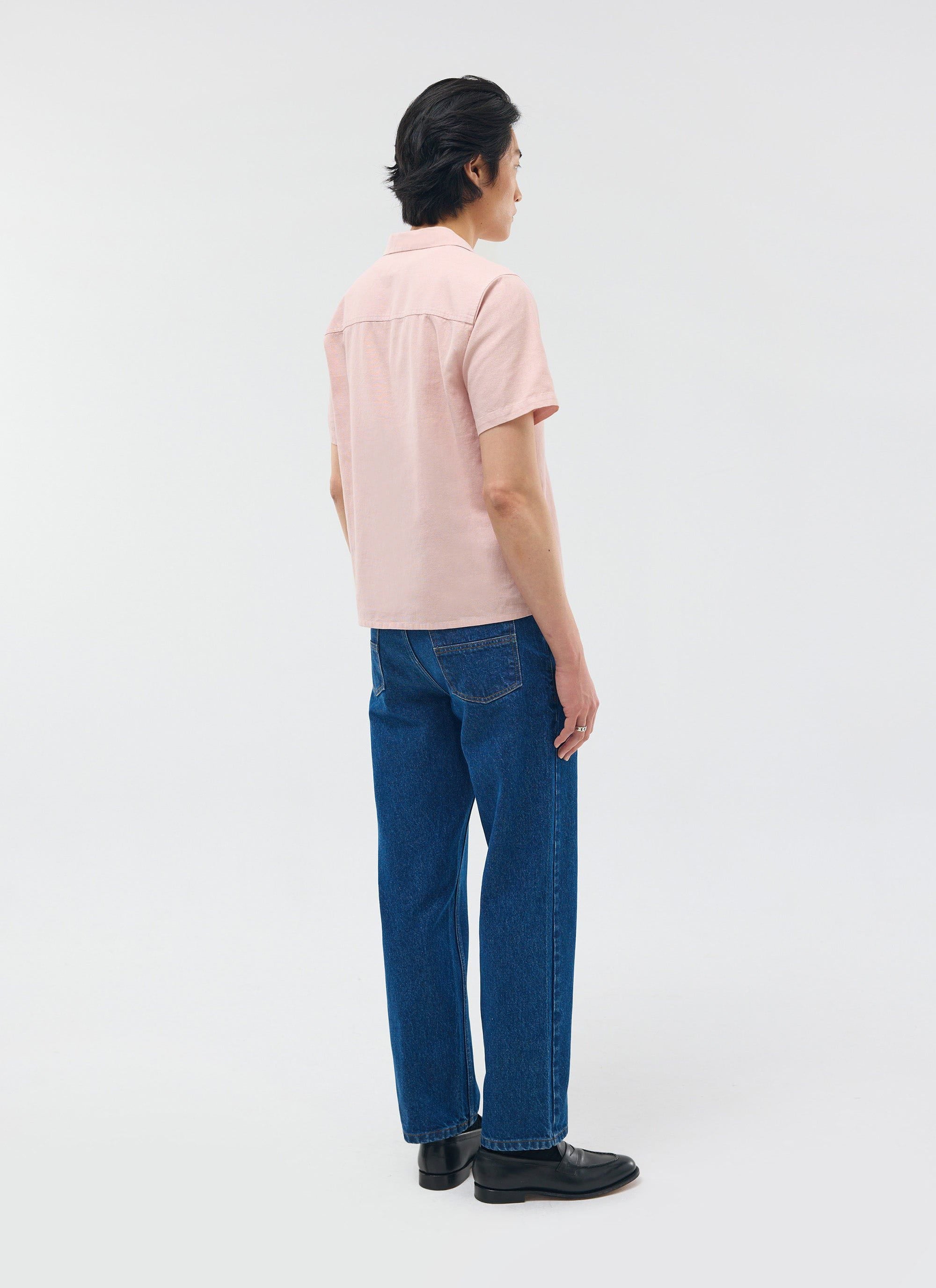 The Percival Short Sleeve Cuban Shirt in dusty pink linen, shown from behind on a model styled with blue jeans.