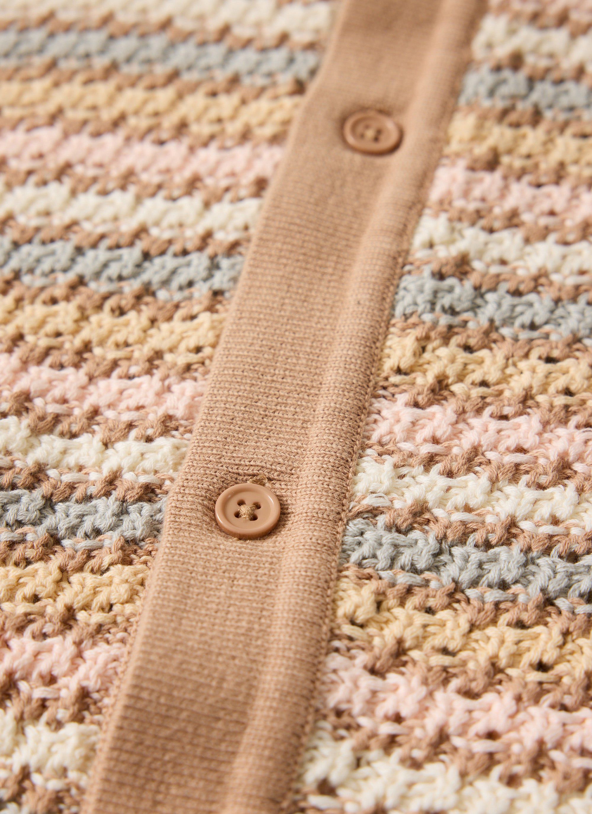 Close up of the multi-coloured striped cotton knit and button detail on the Sari Stripe Knitted Shirt from Percival.