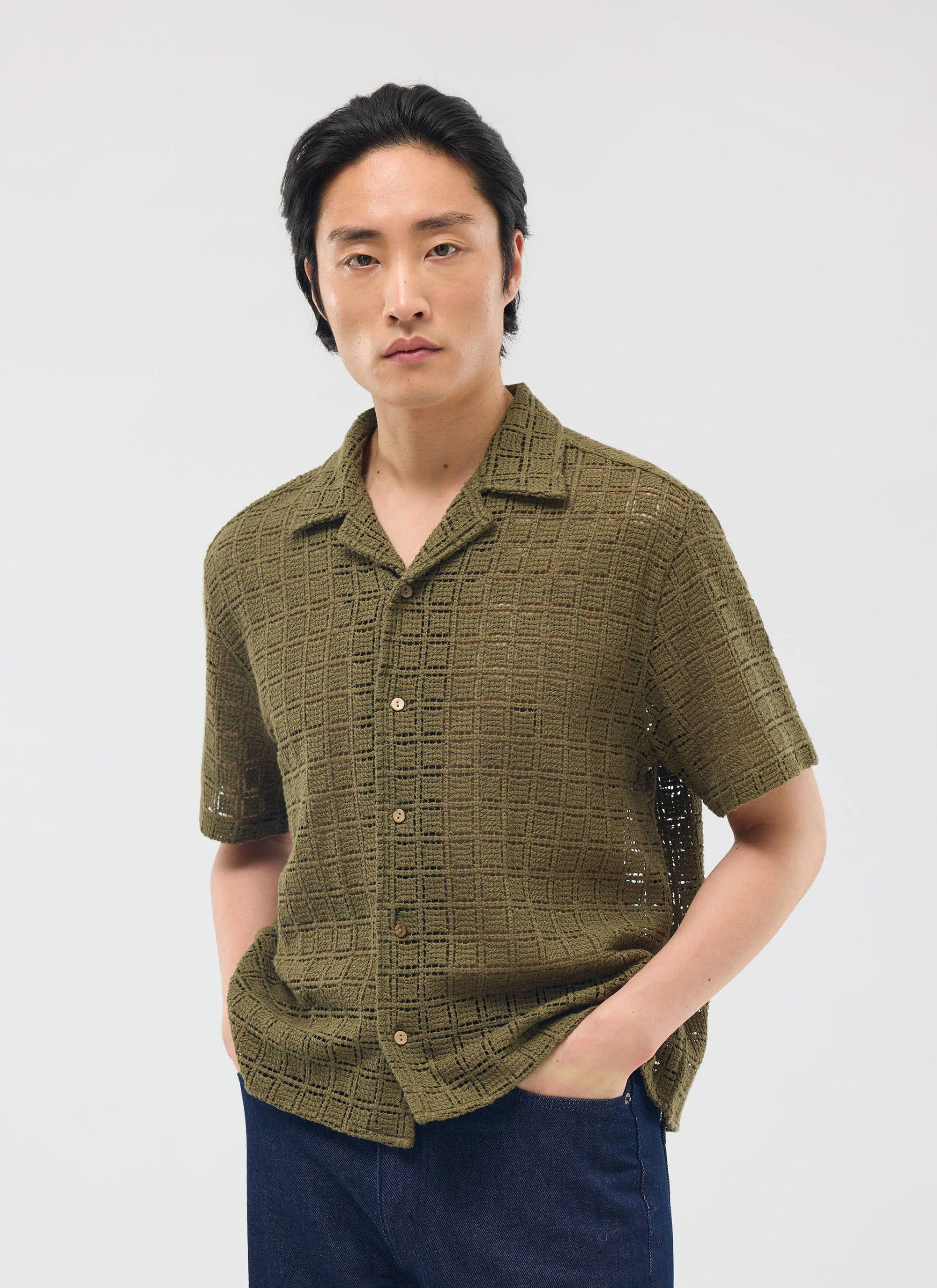 A model wears the olive green Palermo Crochet Cuban Shirt from Percival, standing against a clean white studio background.