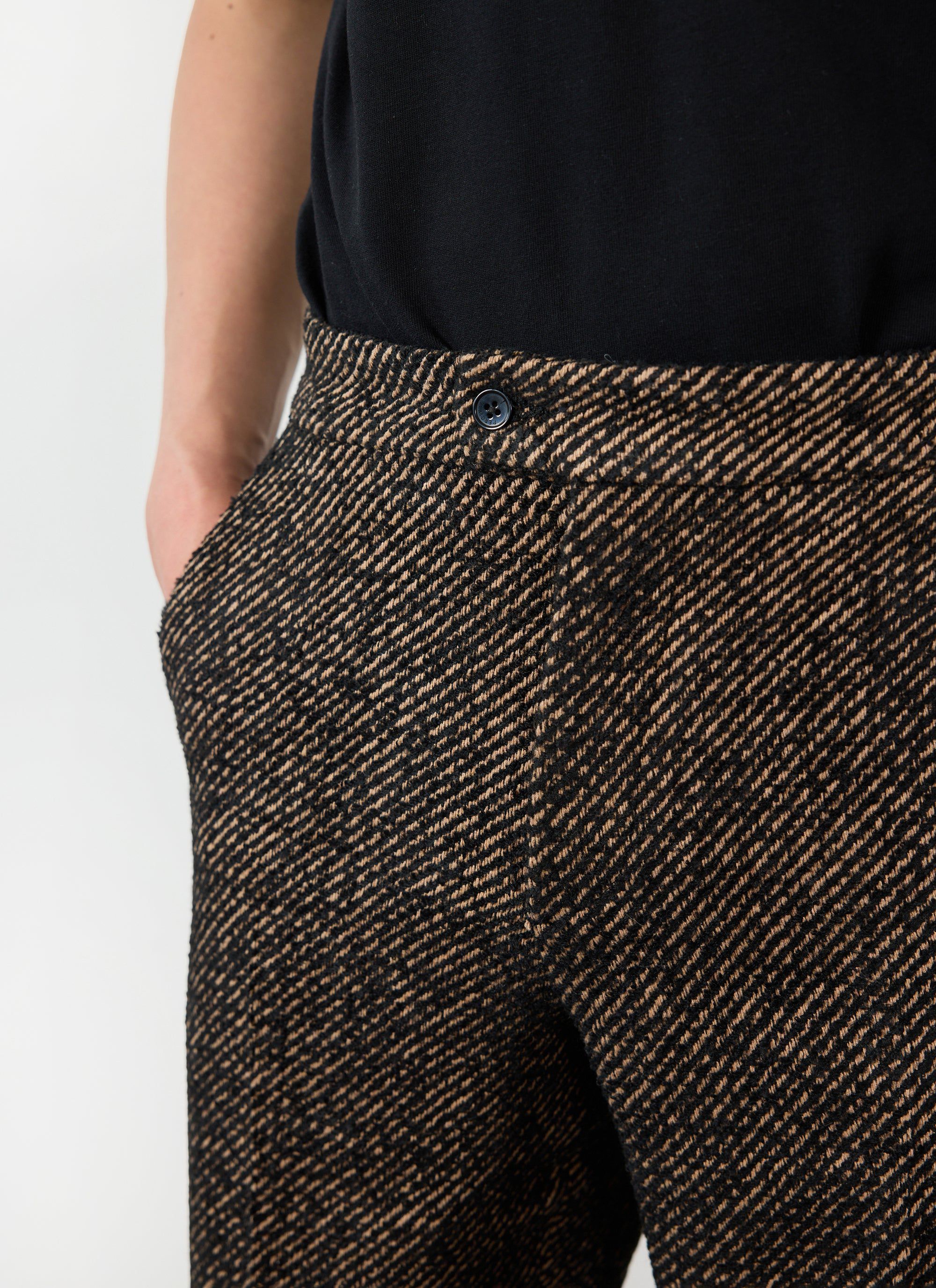 Close up of the Percival Oak Twill Slack Trousers being worn by a model against a white background.