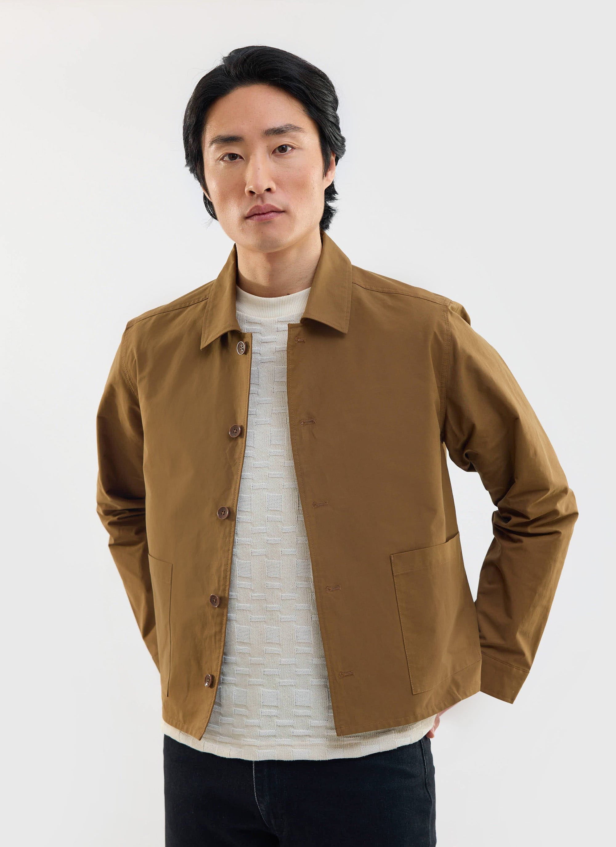 A model wears the Percival Boxy Cropped Pocket Overshirt in brown over a textured cream knit against a white background.
