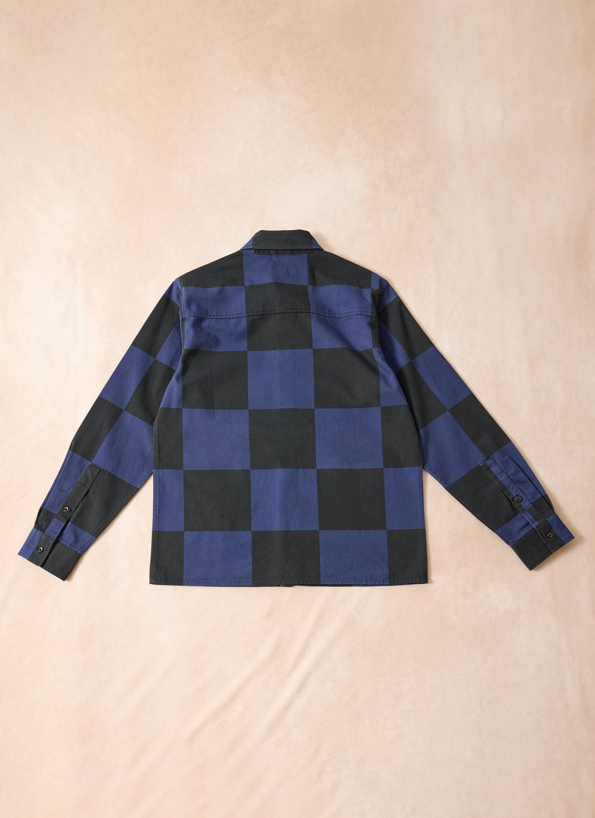 Percival x Ford navy and black checkerboard printed overshirt, laid flat to show the back view.
